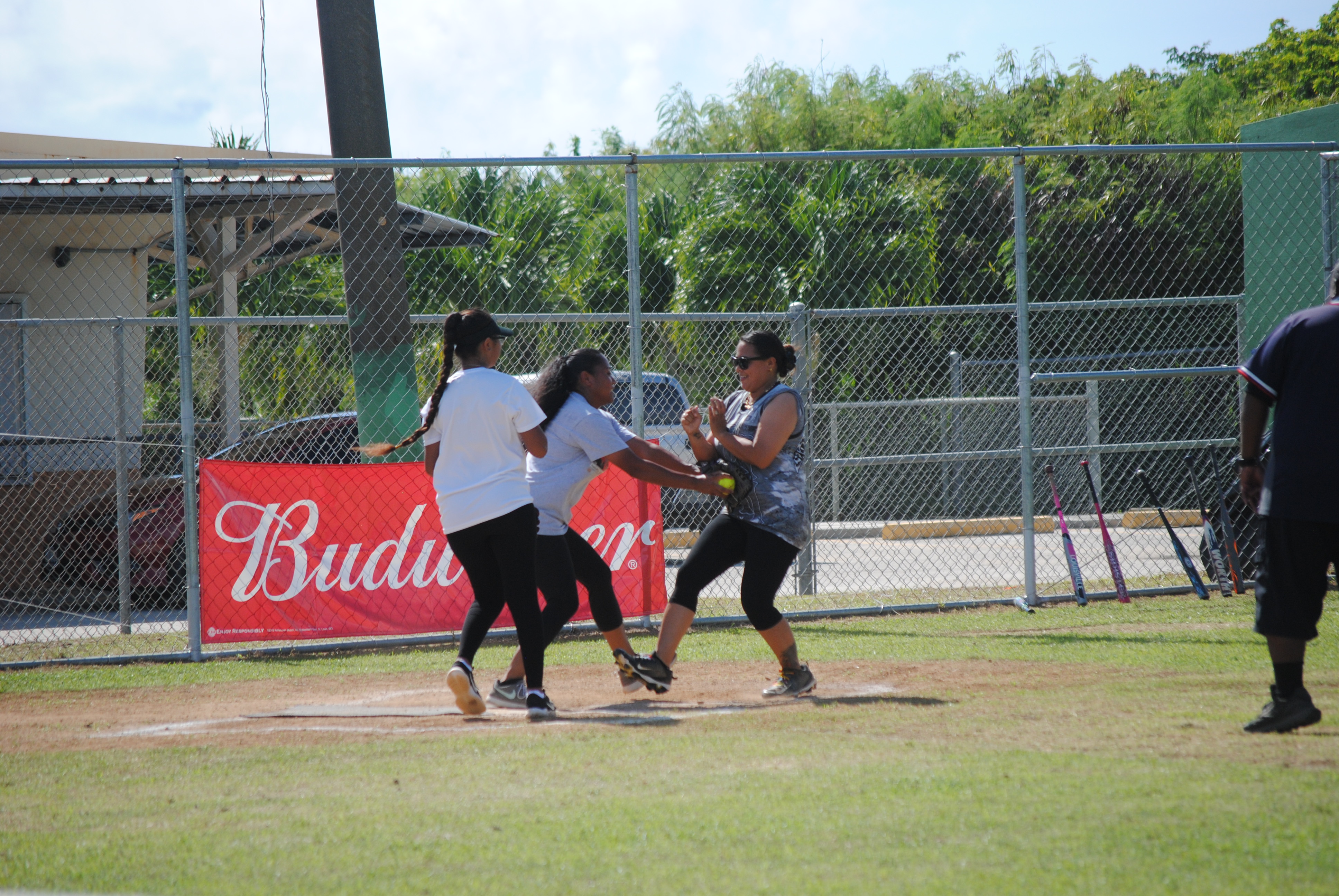 Lady Eagles' pitcher Emy tags a runner out at home plate during a Ladies Division game of the Budweiser Belau Amateur Softball League on Sunday at the Dandan baseball field.