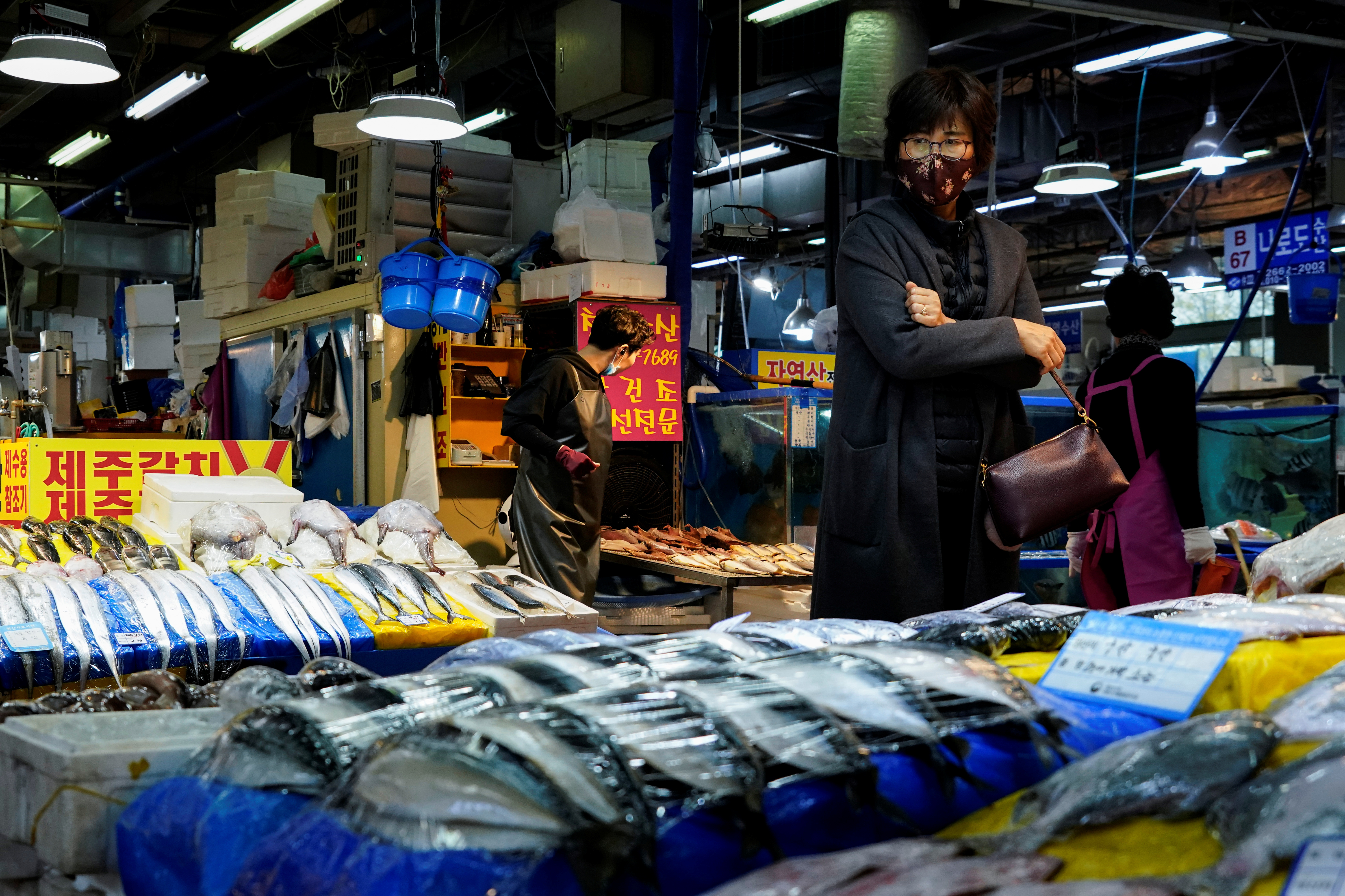 A woman wearing a protective mask is seen at a fish market in Seoul, South Korea, April 5, 2020