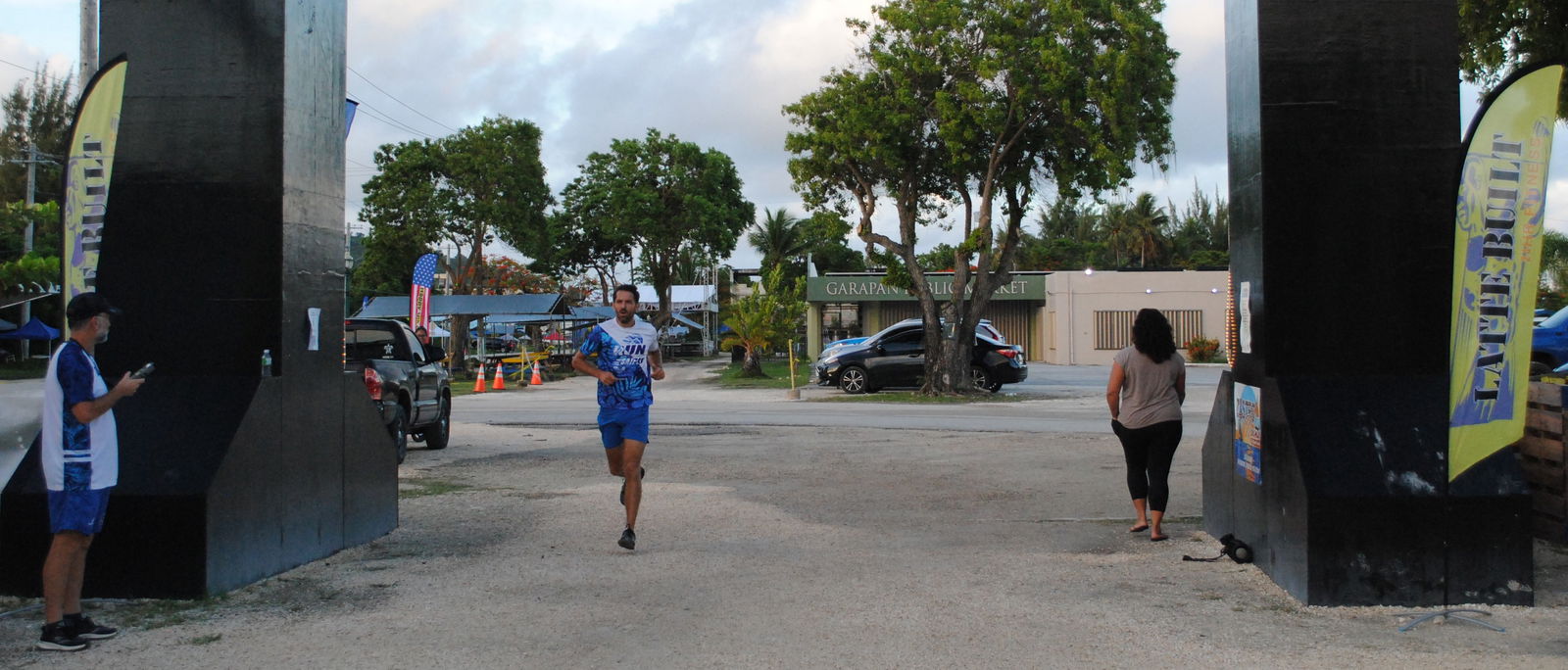 Michael Denevan crosses the finish line  of the 2nd Annual 4th of July two-mile race at the Garapan Fishing Base.
