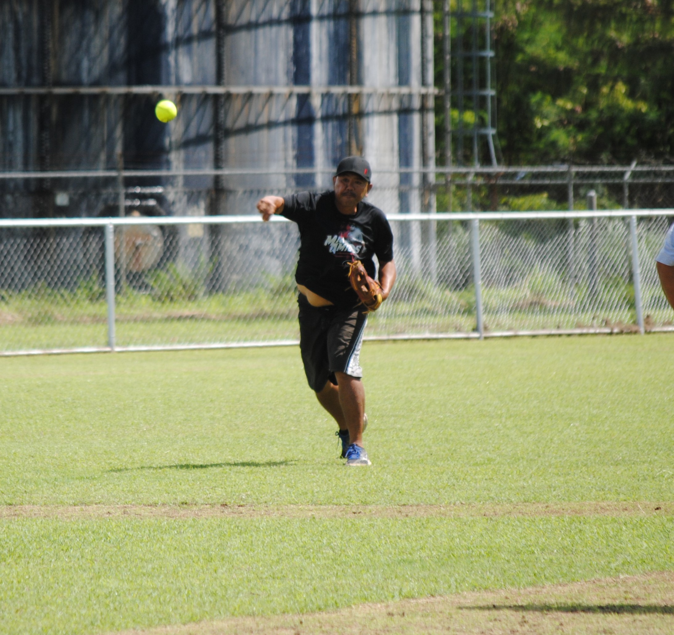 Man Amigos' shortstop Mario throws to home for the out.