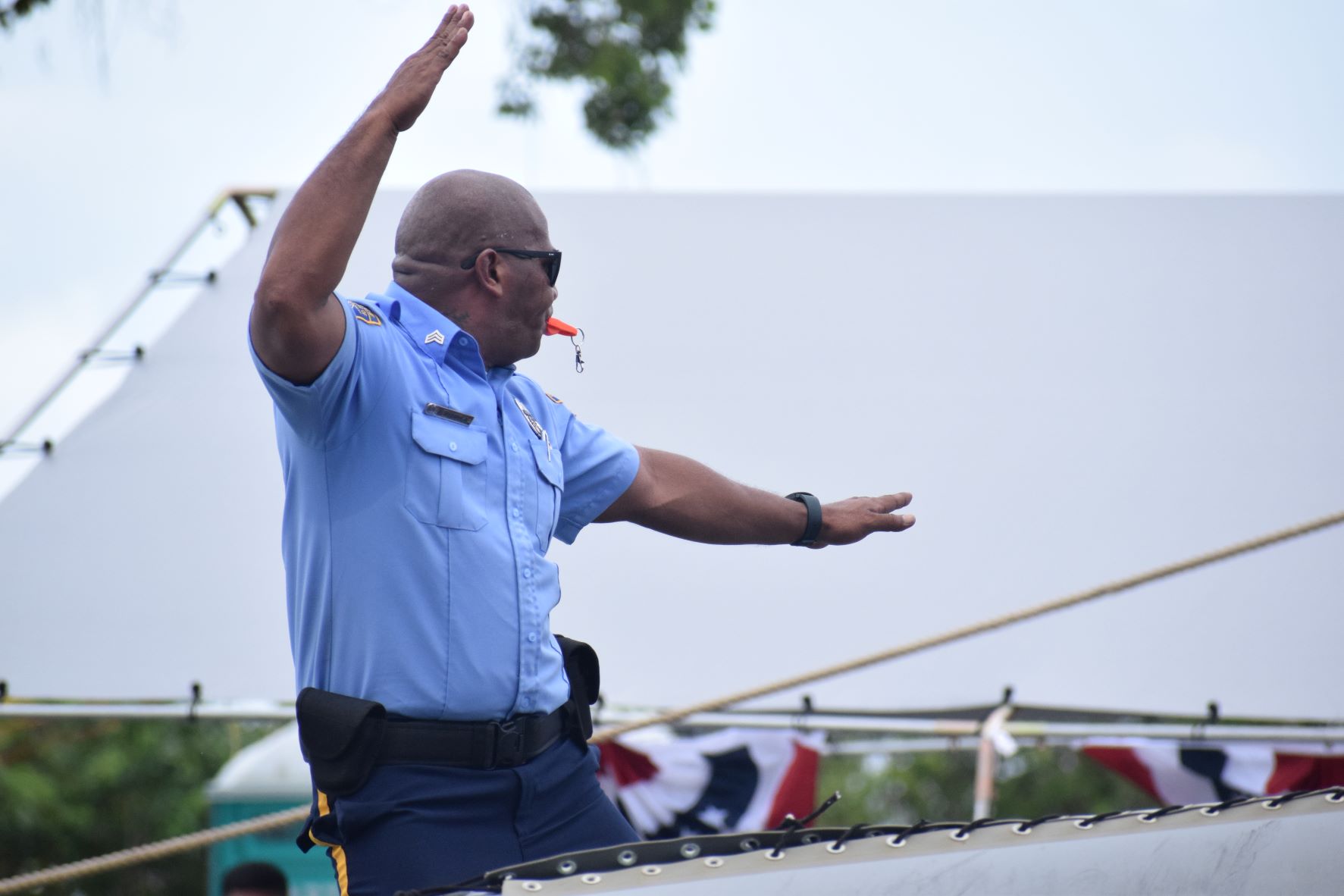 Police Officer Patrick "Chinaman" Arriola entertains the crowd with his fancy dance moves as the Department of Public Safety's float passes by.