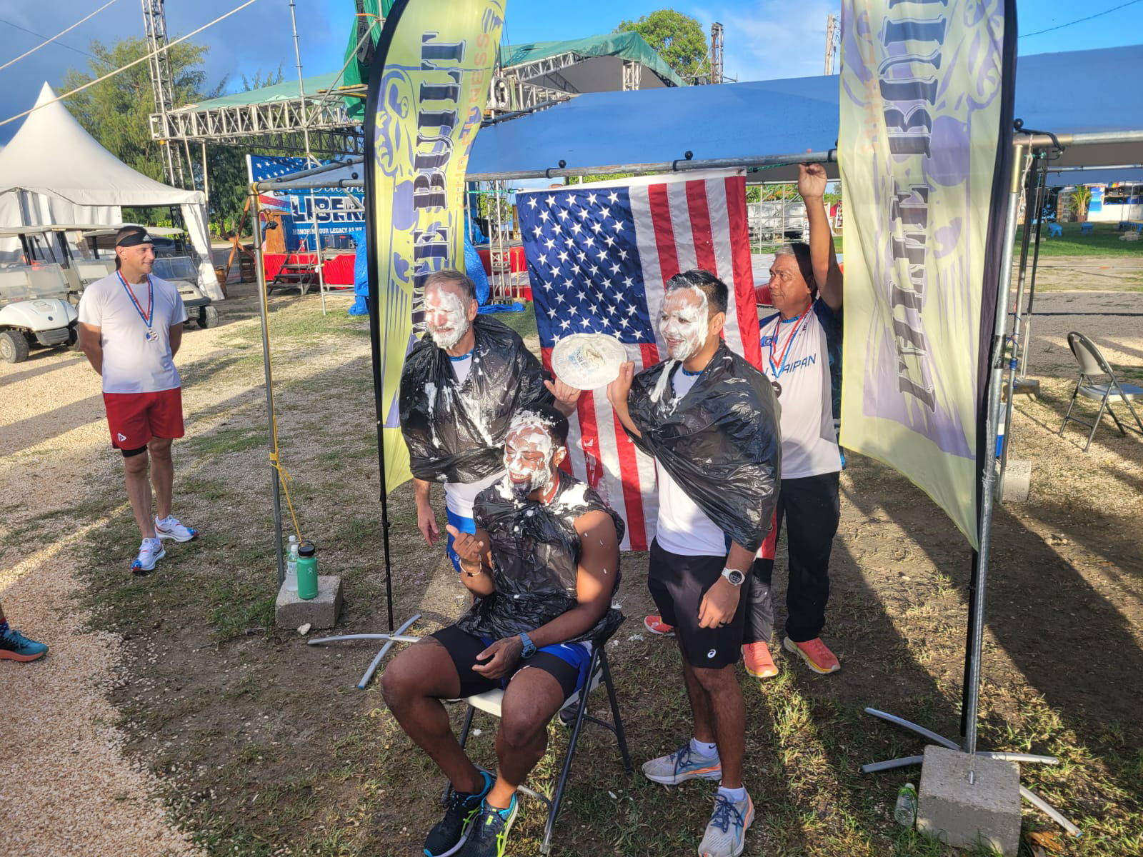 Dr. Ron Snyder, Coach David Shamburger and Run Saipan President Edward Dela Cruz Jr. pose for a photo after getting pied.