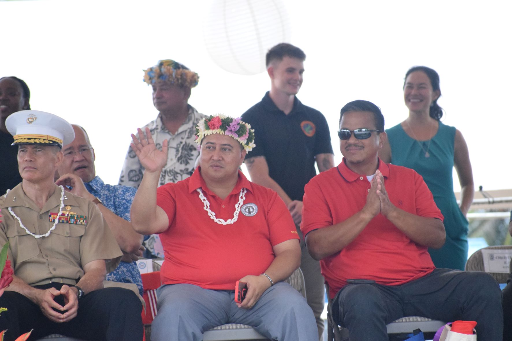 Gov. Ralph DLG Torres waves at parade participants as Senate President Jude U. Hofschneider applauds. With them are Maj. Gen. Mark Hashimoto, the mobilization assistant to the commander of U.S. Indo-Pacific Command. Behind are Associate Justice John Manglona, Reps. Richard Lizama and Tina Sablan.