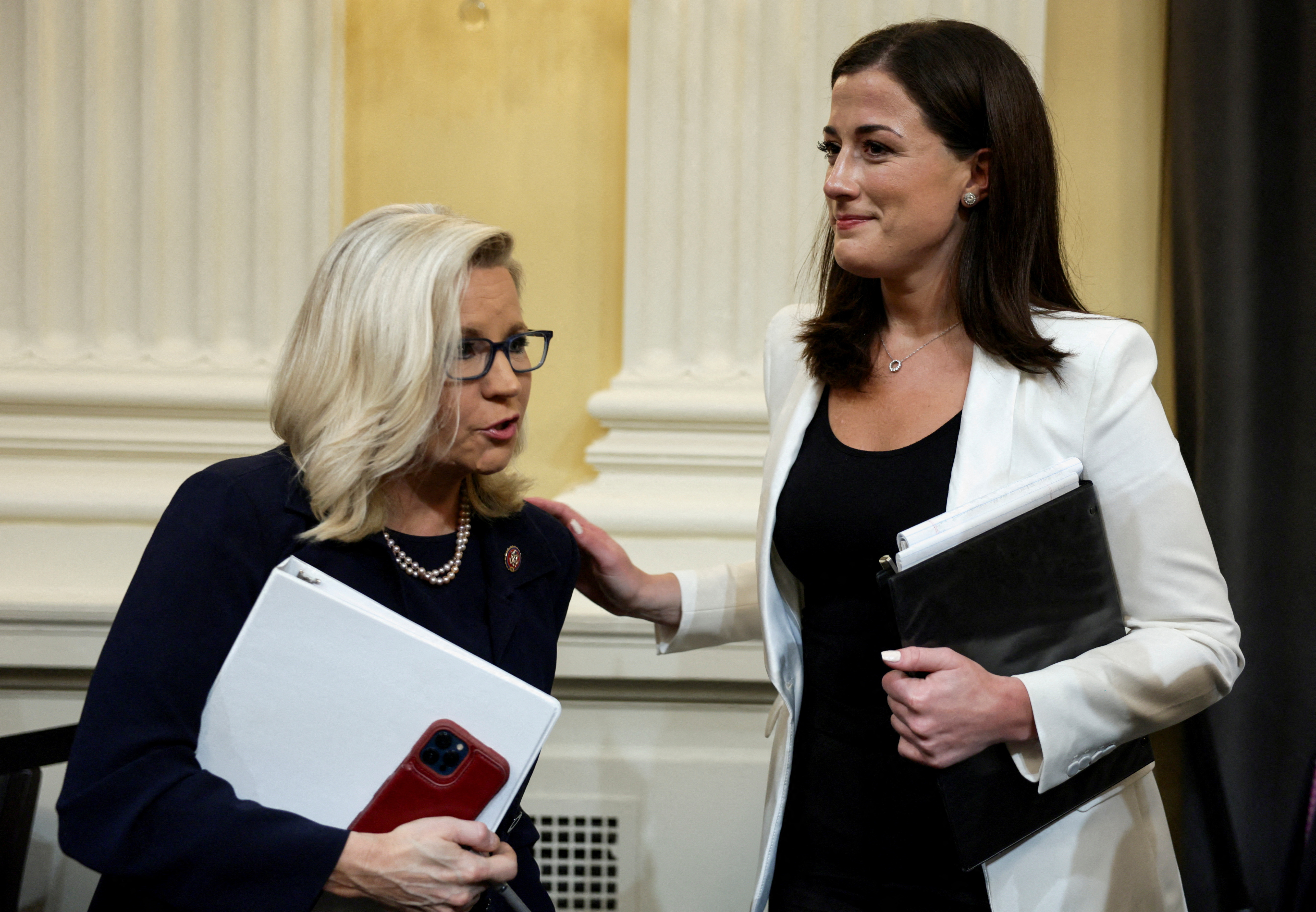 Committee Vice Chair Rep. Liz Cheney, R-WY, talks with Cassidy Hutchinson, who was an aide to former White House Chief of Staff Mark Meadows, after Hutchinson concluded her testimony during a public hearing of the U.S. House Select Committee to investigate the January 6 Attack on the U.S. Capitol, on Capitol Hill in Washington, D.C., June 28, 2022.