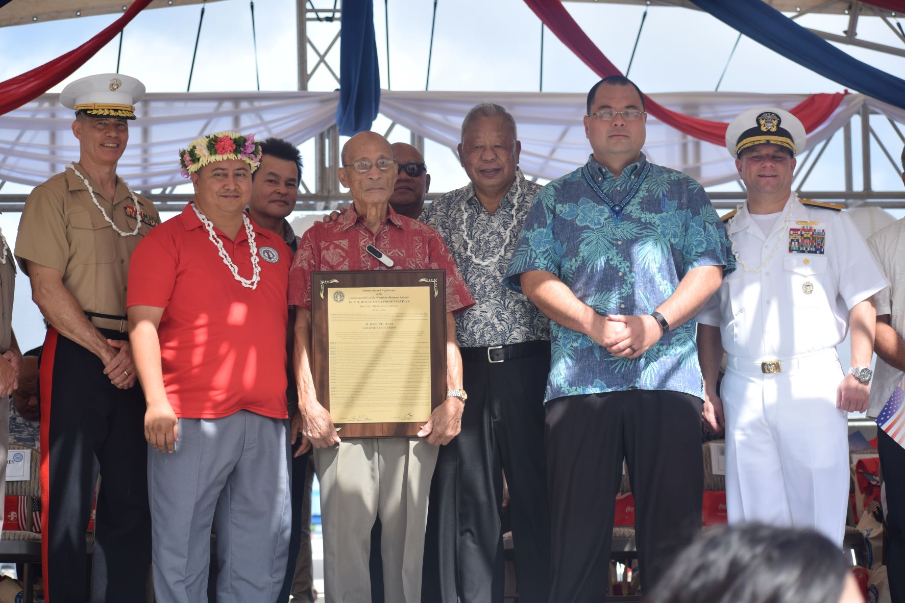 World War II survivor David "Uncle Dave" Mangarero Sablan, center, poses for a photo with Gov. Ralph DLG Torres, second left, Saipan Mayor David M. Apatang, third right, Speaker Edmund S. Villagomez, second right, Indo-Pacific Commander Maj. Gen. Mark Hashimoto, left, and Joint Region Marianas Commander Rear Adm. Benjamin Nicholson, right, during the presentation of House Resolution 22-21 to Uncle Dave on July 4, 2022.