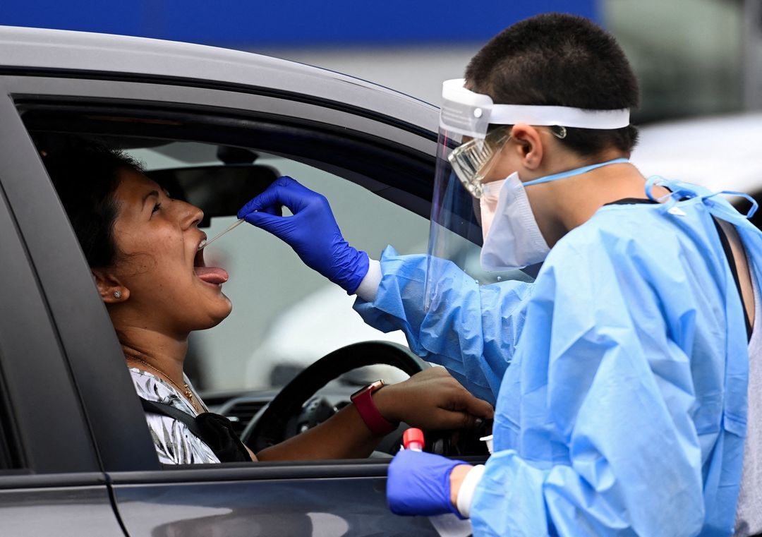 A woman takes a test for the coronavirus disease at a testing center in Sydney, Australia, Jan. 5, 2022.
