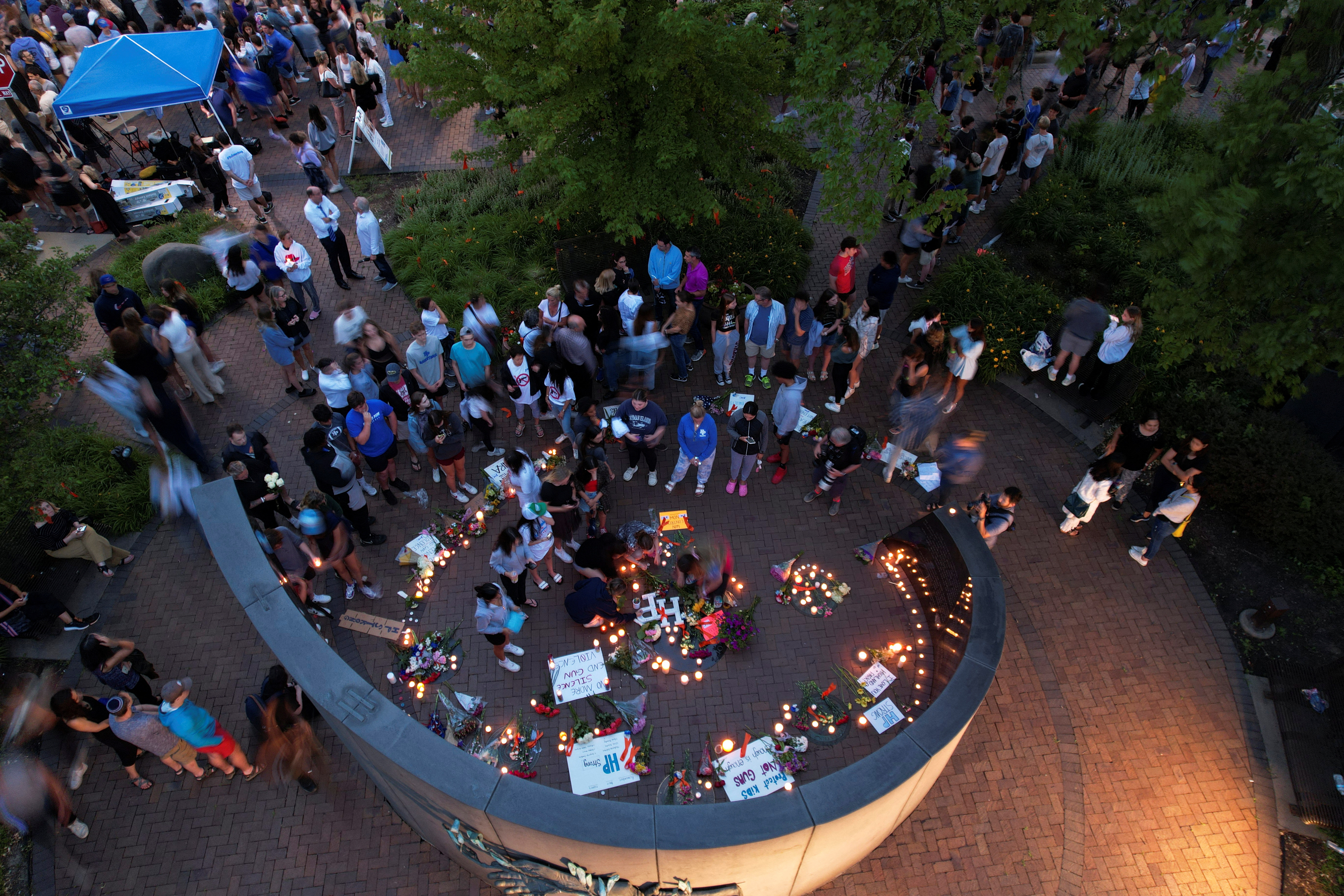 Community members gather at a memorial site near the parade route the day after a mass shooting at a Fourth of July parade in the Chicago suburb of Highland Park, Illinois on July 5, 2022.