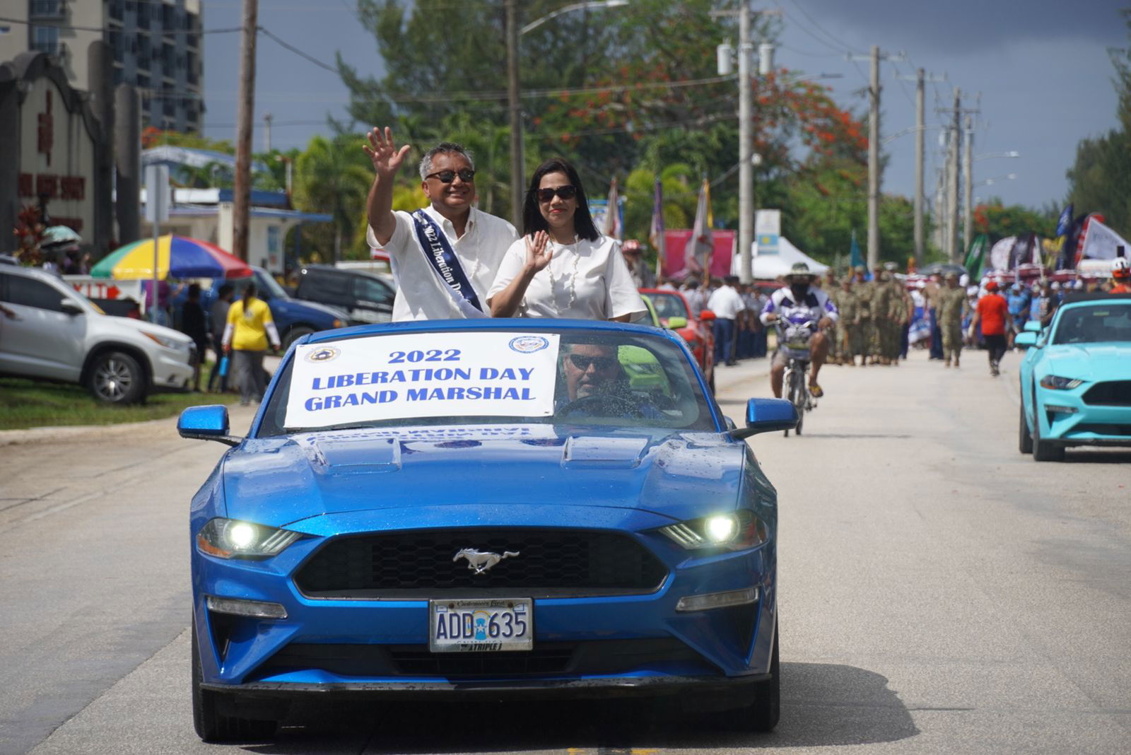 2022 Liberation Day grand marshal Mike Sablan and his wife, Violeta, wave at the crowd. 