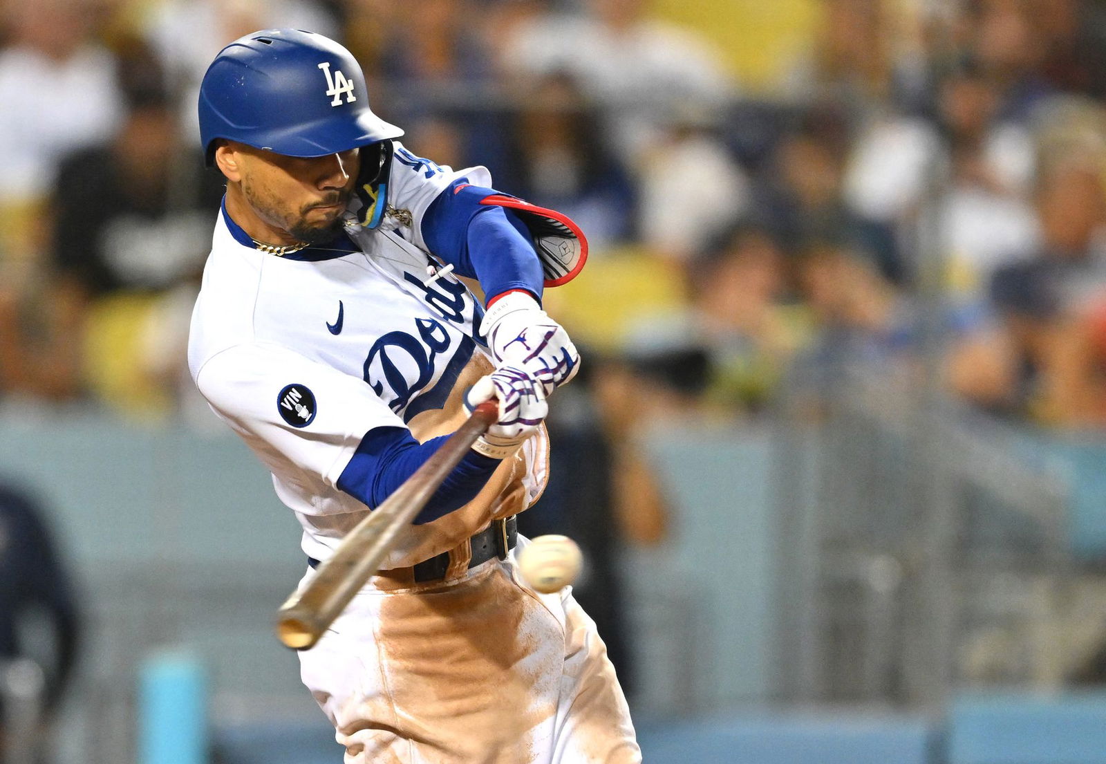 Los Angeles Dodgers right fielder Mookie Betts (50) singles in the sixth inning against the San Diego Padres at Dodger Stadium in Los Angeles, California, Aug. 5, 2022.