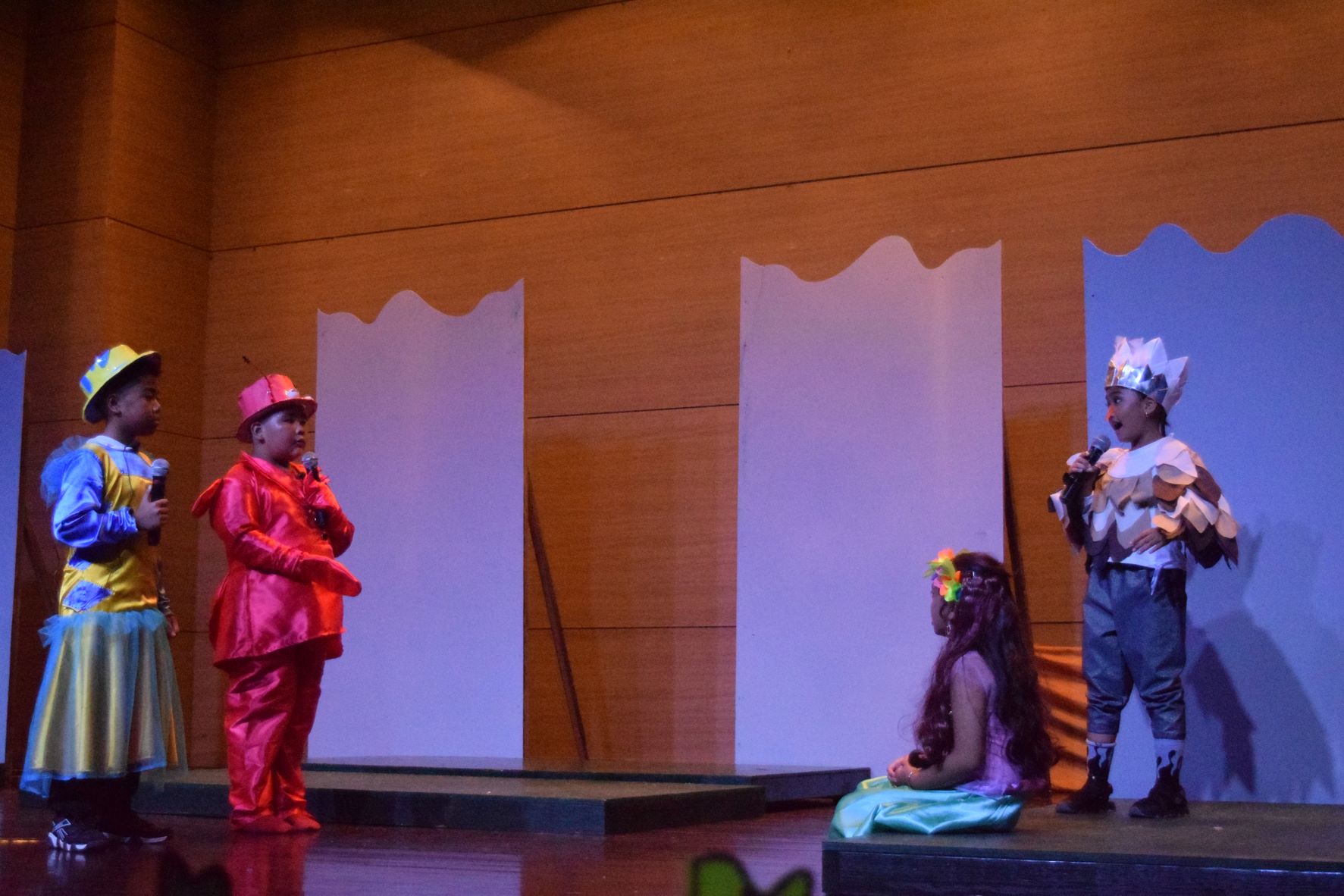 Sebastian, portrayed by third grader Leyland Duenas, talks to Ariel and Scuttle as Flounder looks on.