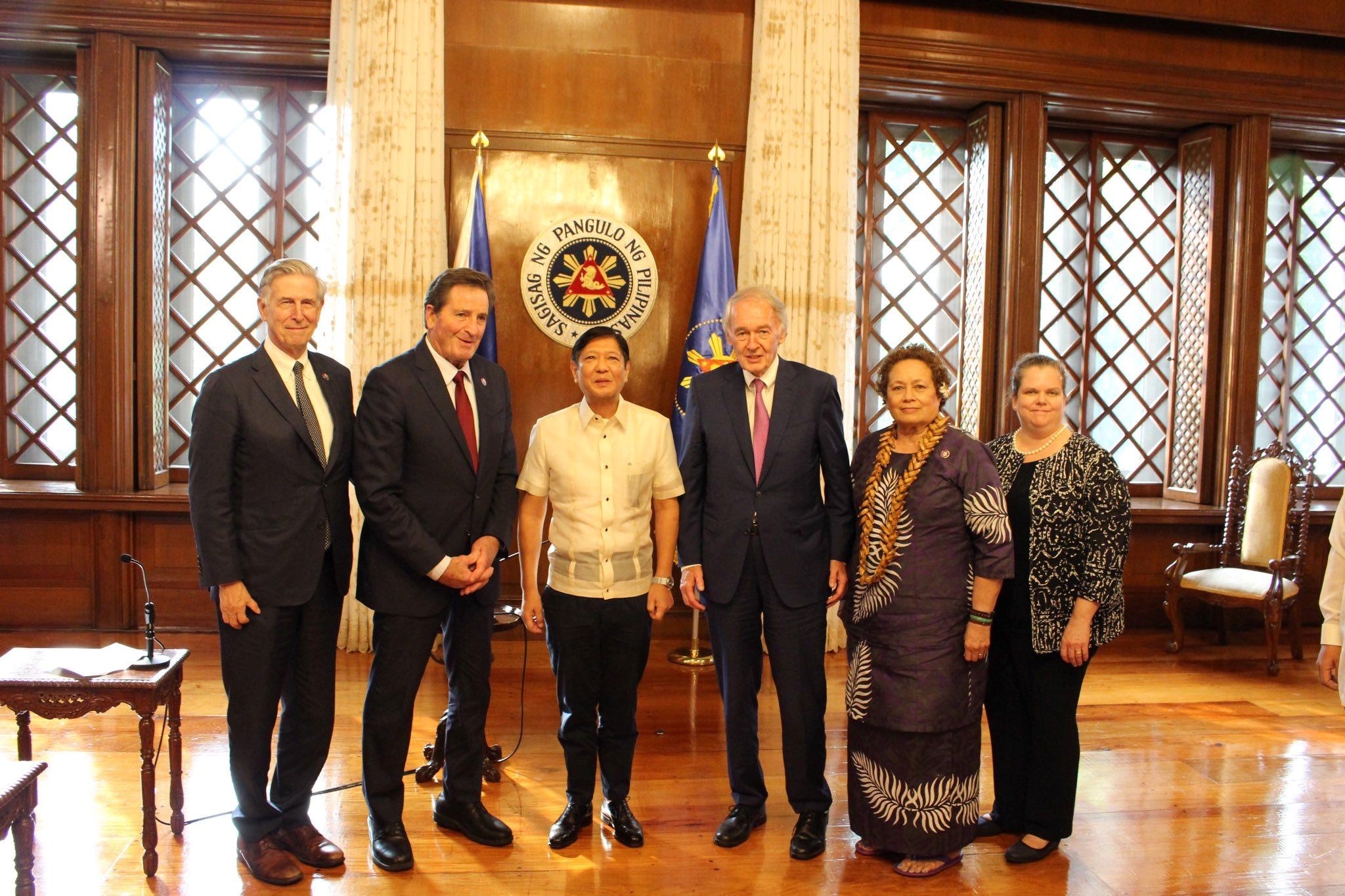 Philippine President  Ferdinand Marcos Jr., 3rd left poses for a photo with the visiting U.S. lawmakers at the Malacañang presidential palace in Manila on Thursday.