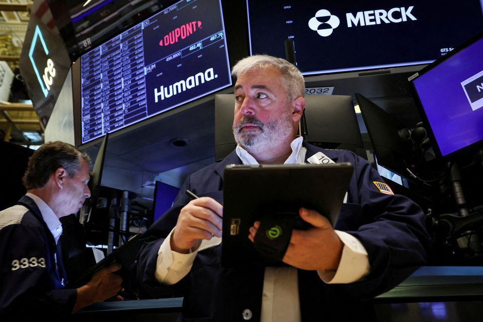 Traders work on the floor of the New York Stock Exchange in New York City, Aug. 15, 2022.