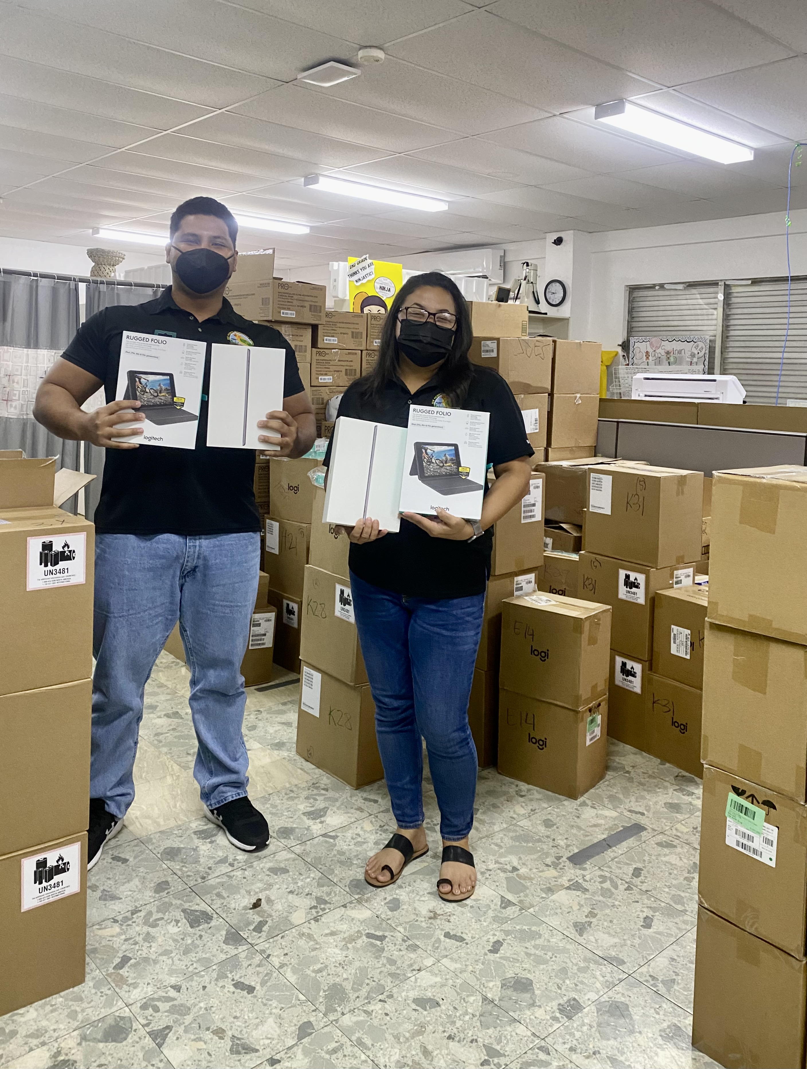 San Vicente Elementary School Principal Paulette Tomokane, right, and a colleague, show the brand new iPads and iPad keyboards for students.