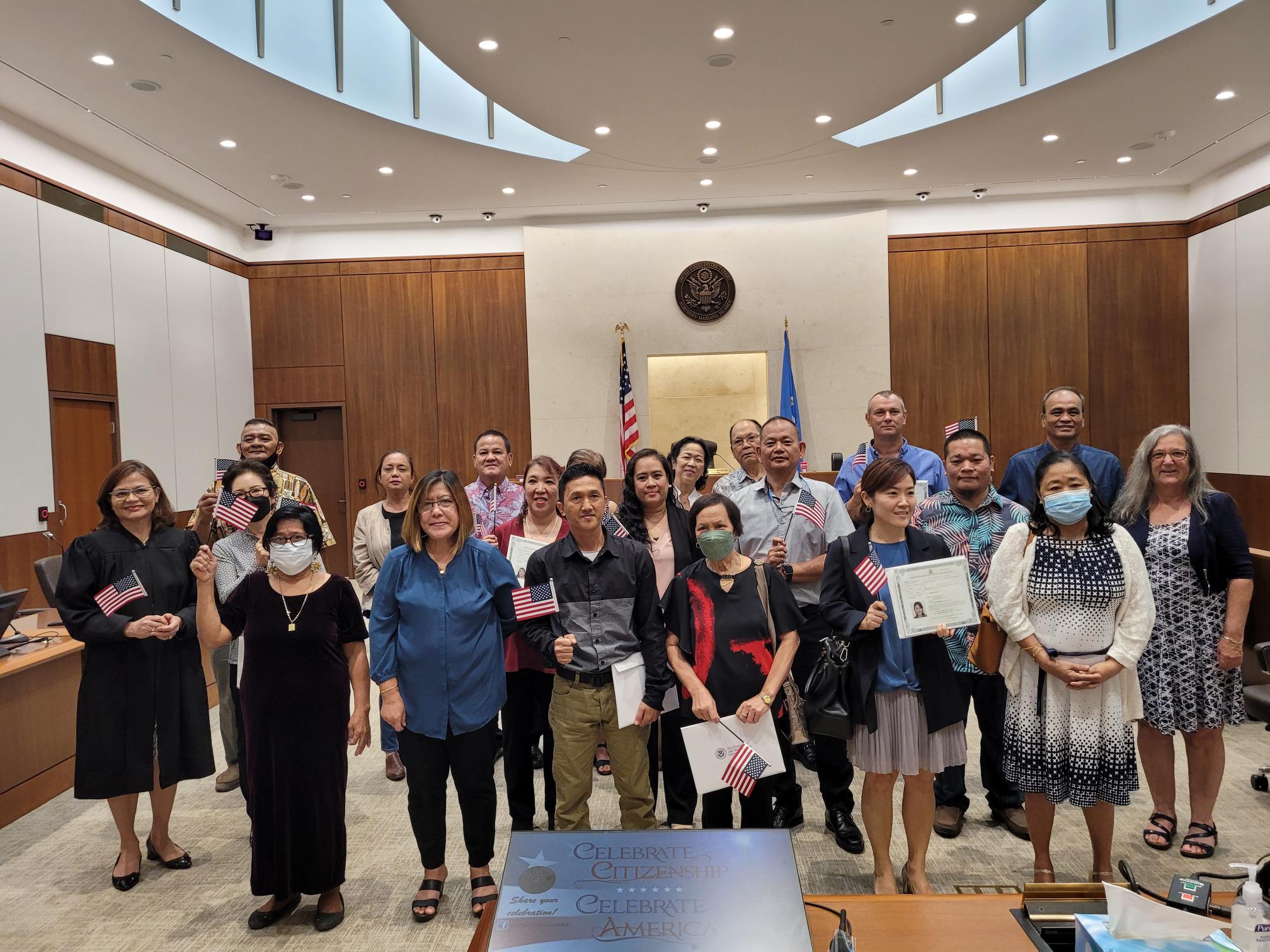 The new U.S. citizens who were sworn in Monday morning pose for a photo with Chief Judge Ramona V. Manglona of the District Court for the NMI, U.S Coast Guard Lt. Cmdr. Christine Torres Igisomar and U.S. Citizenship and Immigrations Services Officer Patricia Phelan.