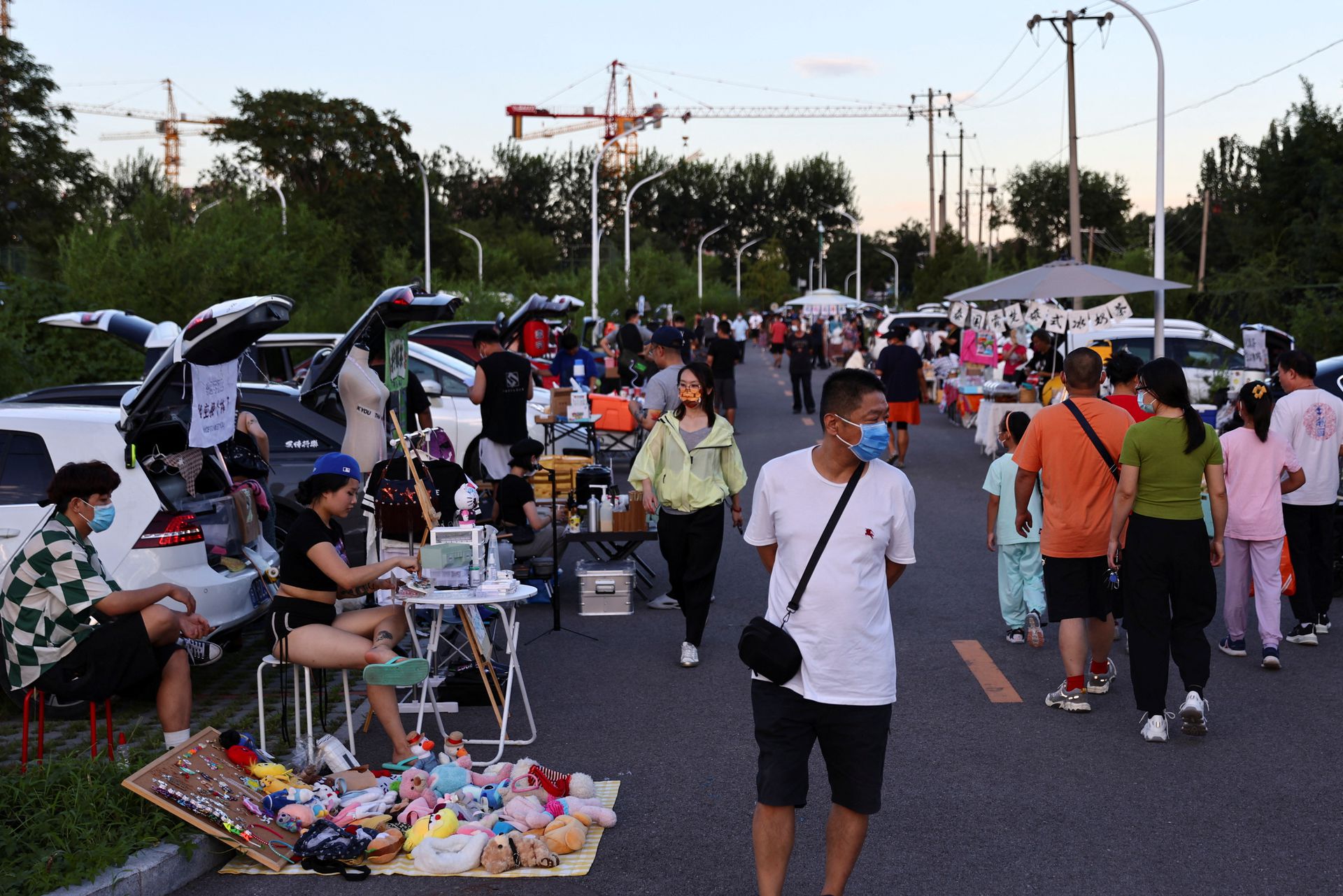 People walk at a car boot fair in Beijing, China, Aug. 19, 2022.