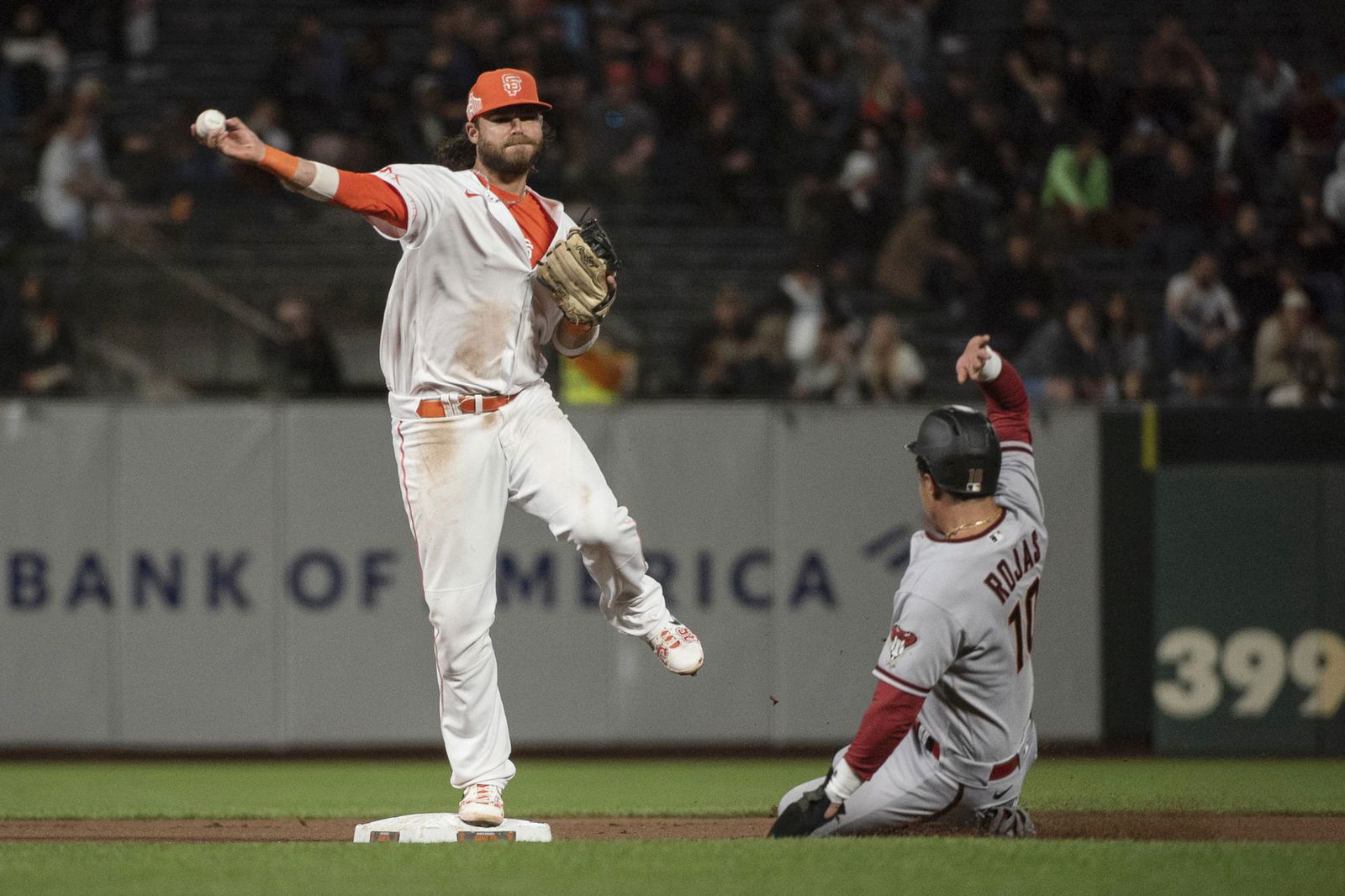San Francisco Giants shortstop Brandon Crawford (35) attempts to turn a double play during the ninth inning against the Arizona Diamondbacks at Oracle Park in San Francisco, California on Aug. 16, 2022.