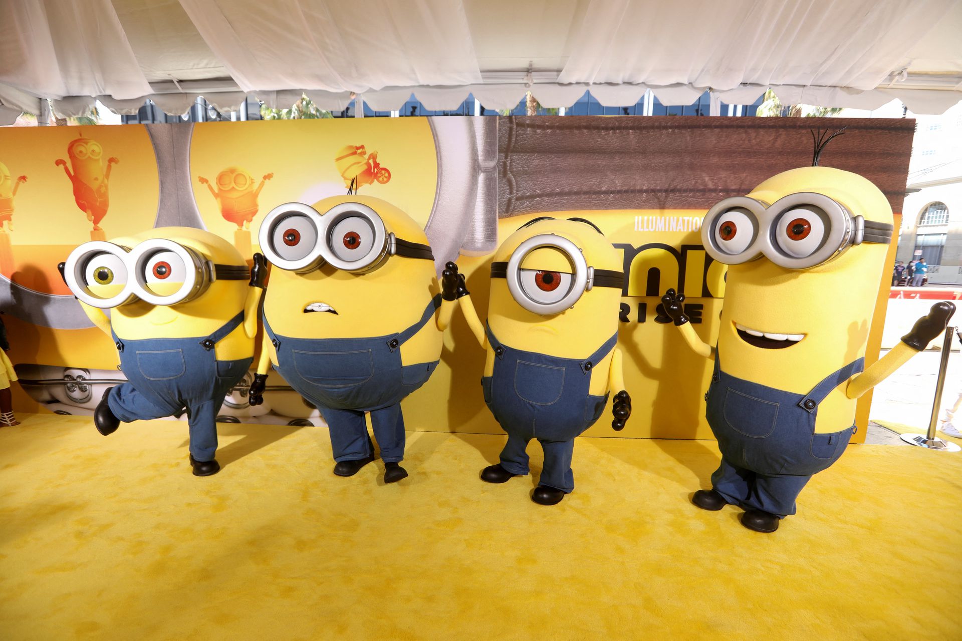 People dressed as the characters Bob, Otto, Stuart and Kevin pose on the red carpet for "Minions: The Rise of Gru" at the TCL Chinese Theatre in Los Angeles, California, June 25, 2022.