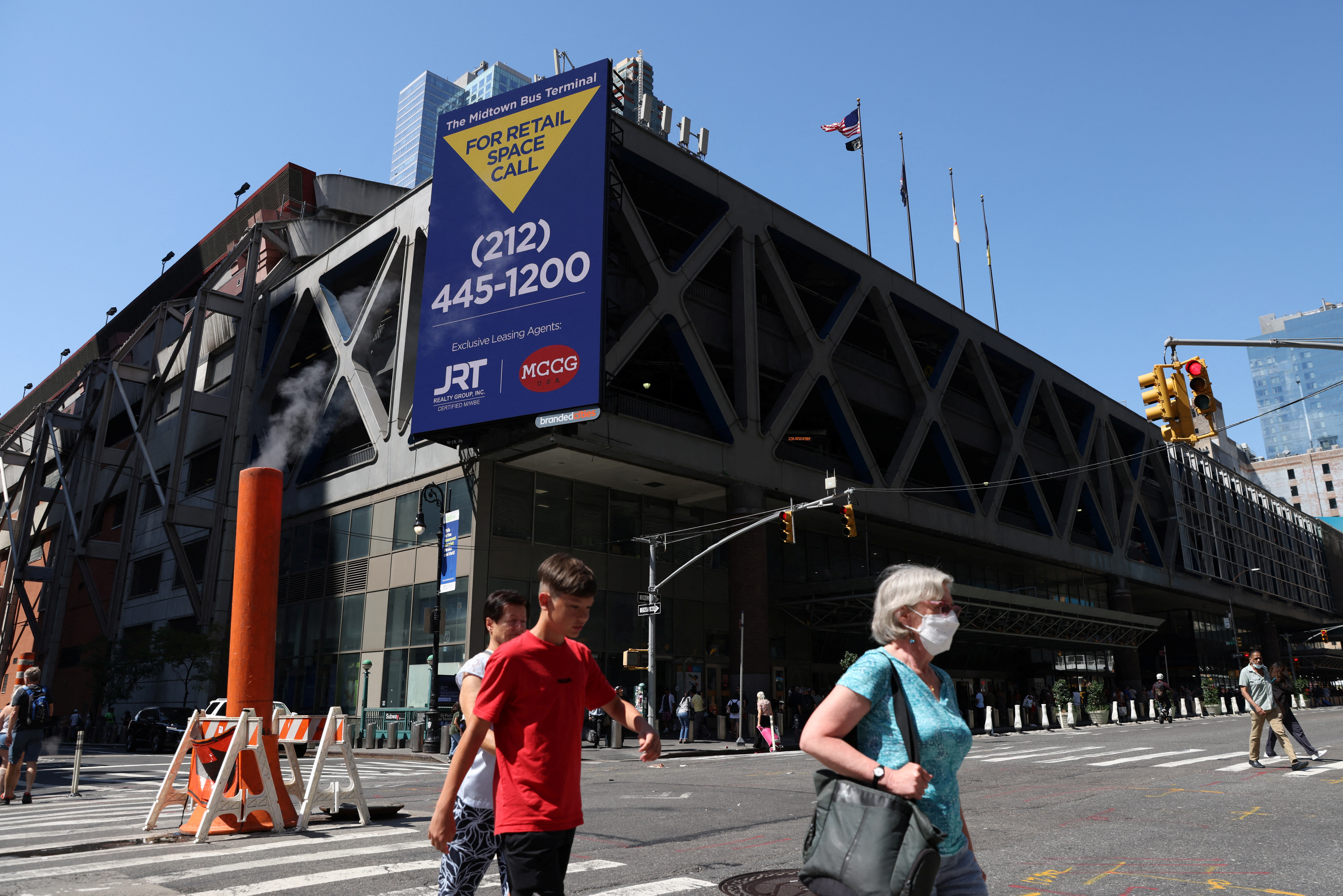 People walk by the Port Authority Bus Terminal in Manhattan, New York City where migrants have arrived from Texas under the order of Texas Gov. Greg Abbott on Aug. 5, 2022.