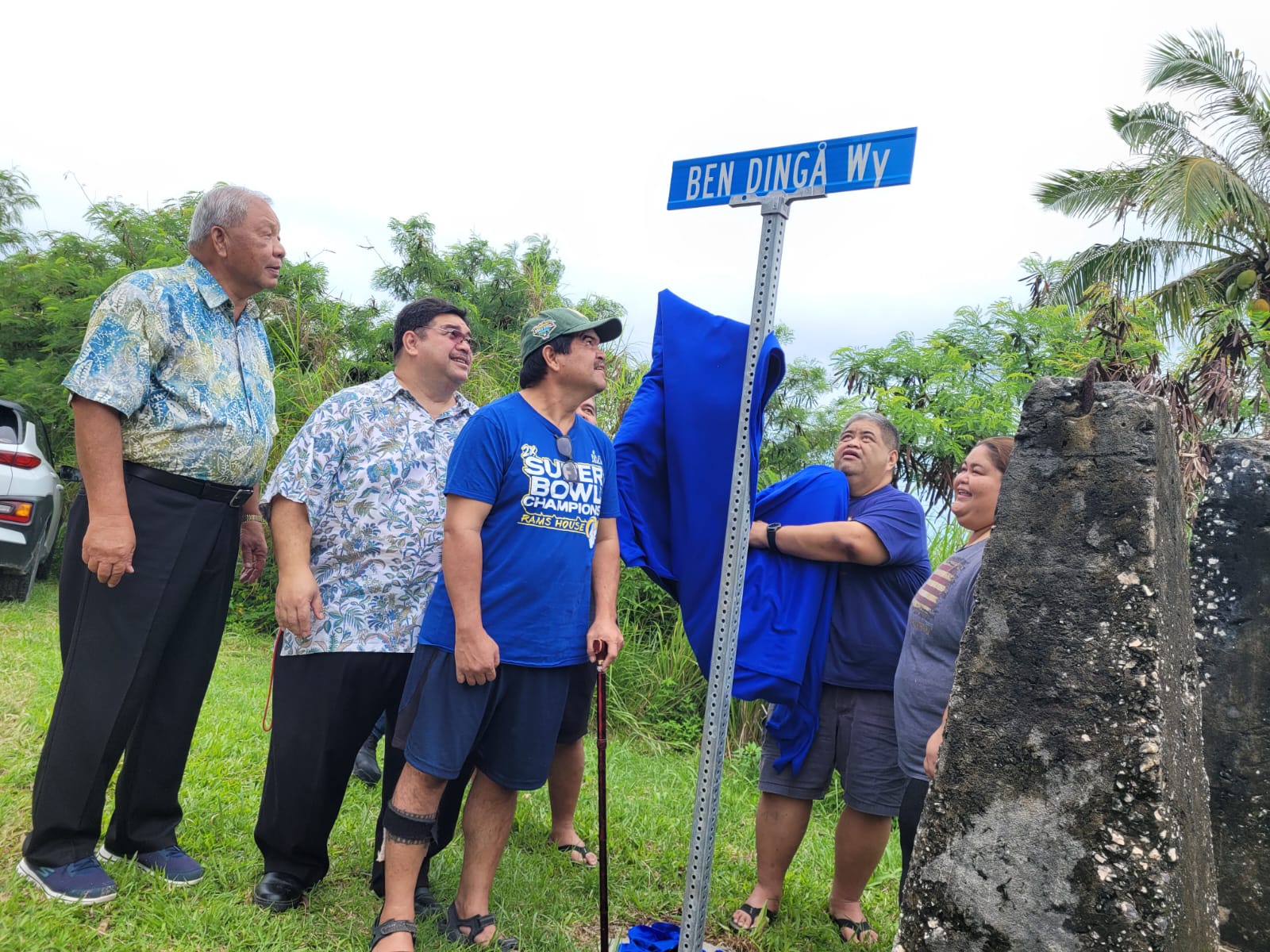 Saipan Mayor David M. Apatang, left, looks on as former Rep. Claudio Norita, second right, unveils the brand-new street sign in honor of Vicente "Ben Dinga" Tudela Camacho on Friday on Capital Hill. Also shown are the other children of Ben Dinga: Associate Judge Joseph N. Camacho, Isidoru Camacho and Loling Camacho.