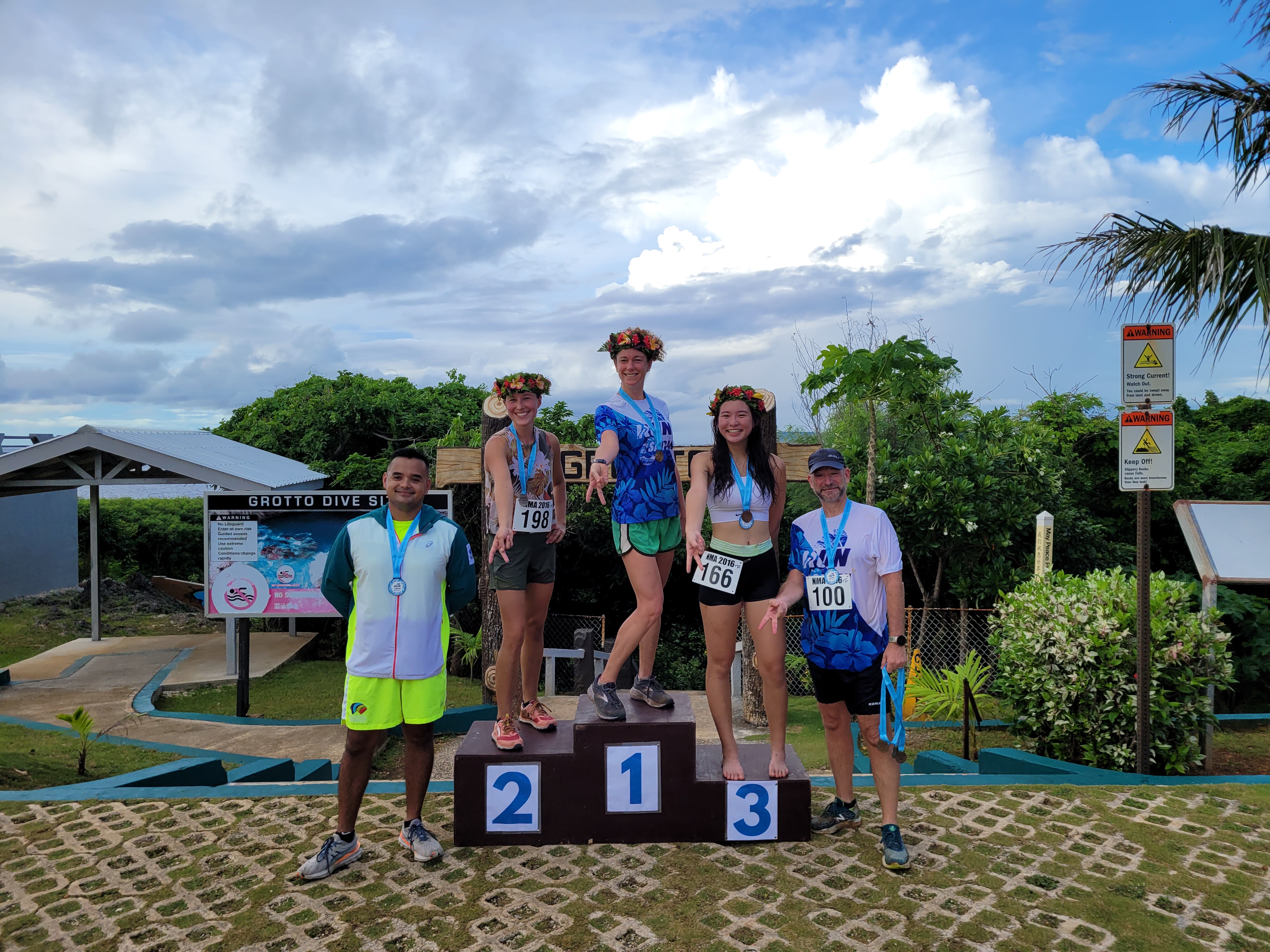 Run Saipan President Edward Dela Cruz Jr. and Secretary/Treasurer Dr. Ron Snyder pose for a photo with the top three female runners Dixie Mendenhall, Lily Muldoon and Tiana Cabrera  during the Grotto 10K award ceremony on Saturday at the Grotto.