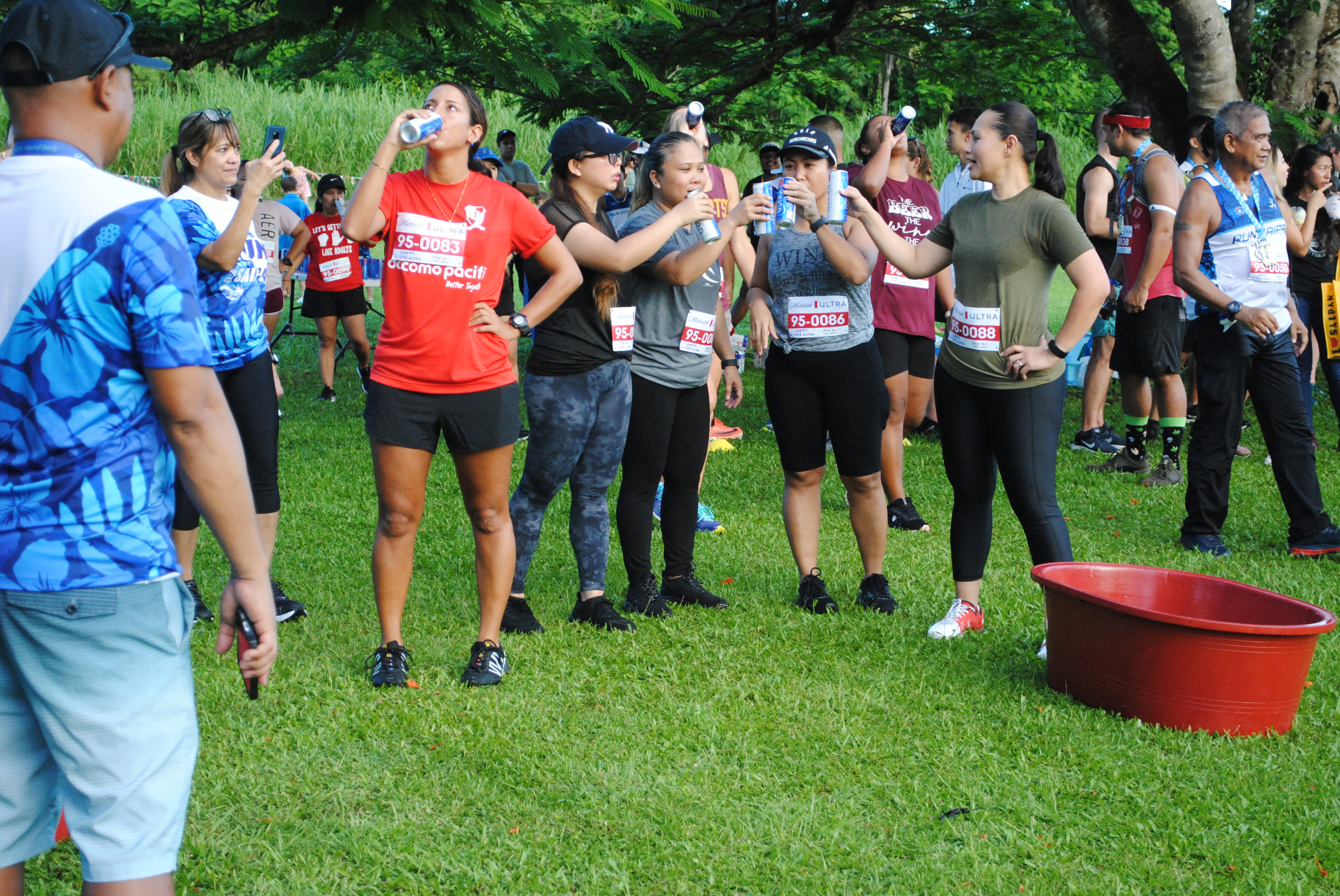 Some of the runners take a moment to say “cheers” as they finish a can of Michelob Ultra. 