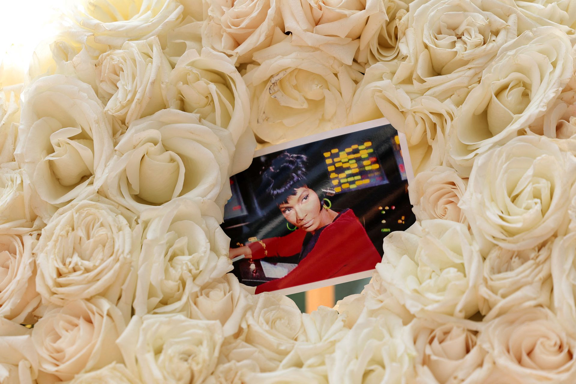 A photograph of late actor Nichelle Nichols is pictured in a rose wreath placed on her star on the Hollywood Walk of Fame in Los Angeles, California,  Aug. 1, 2022.