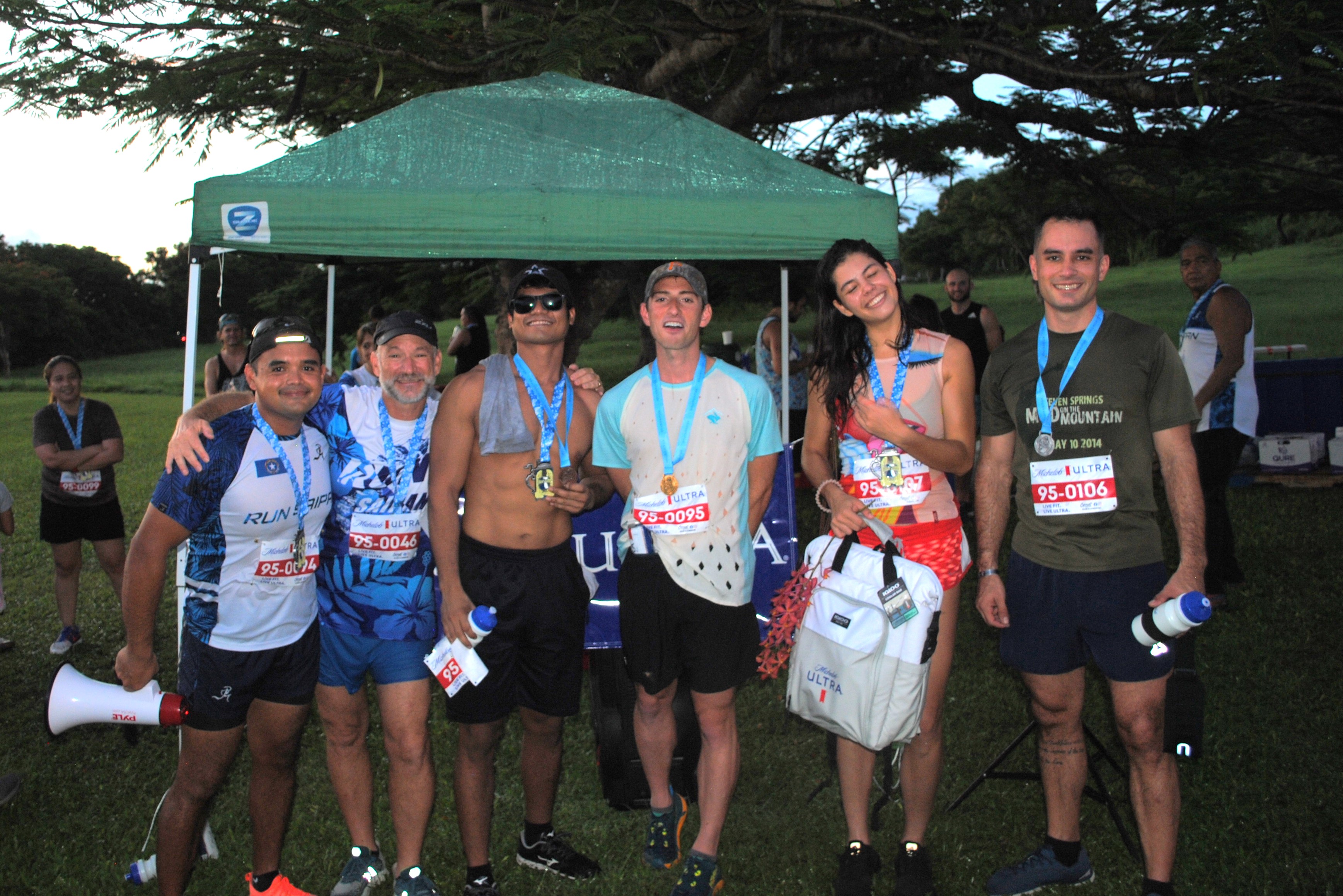 From left, Run Saipan President Edward Dela Cruz, Secretary and Treasurer Dr. Ron Snyder, Vic Sablan, Chace Talbot, Tammy Ackerman and Scott Smith pose with their medals at the conclusion of  the 1st Michelob Ultra Beer Mile on Friday at Saipan Country Club.