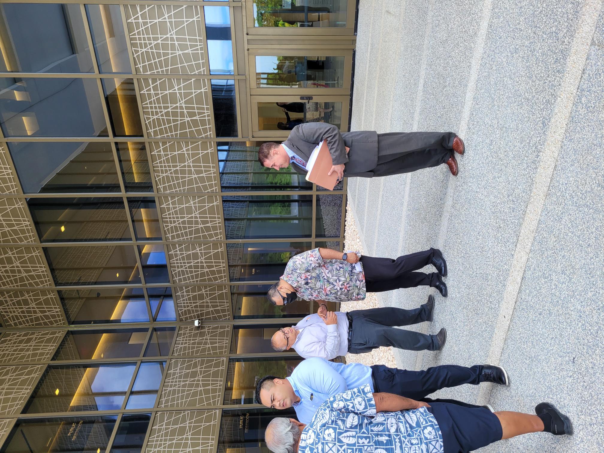 Secretary of Finance David DLG Atalig, 2nd right, talks to Vice Speaker BJ Attao, Jose Mafnas’s son-in-law, at the federal courthouse after a hearing Monday. Atalig is with his attorney, Matthew Gregory, right.