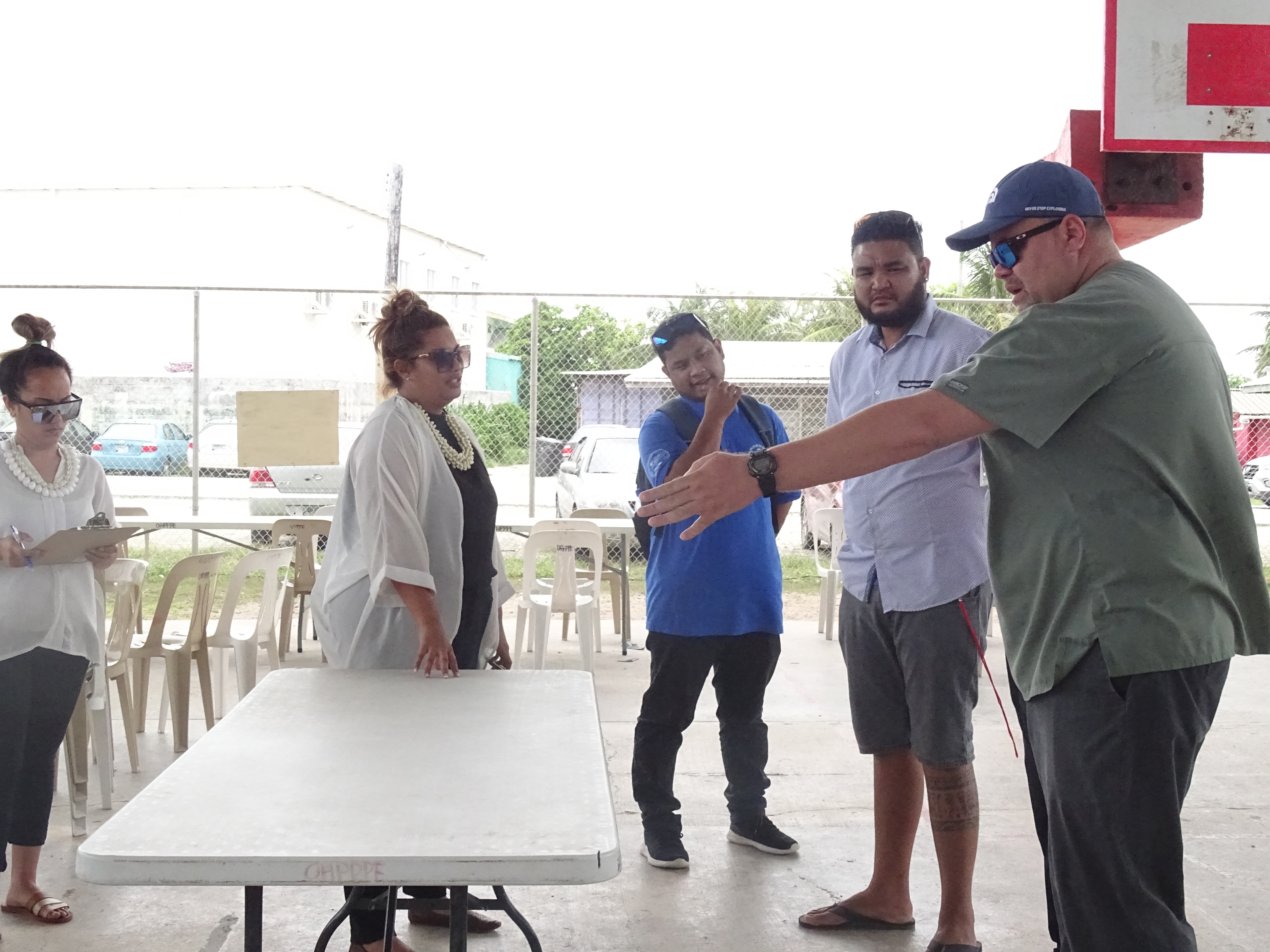 Marshall Islands Director of Public Health Dr. Frank Underwood, right, works with Ministry of Health and Human Services staff to prepare a "test and treat" facility at a Majuro school gymnasium as part of Covid preparations in this file photo from June.