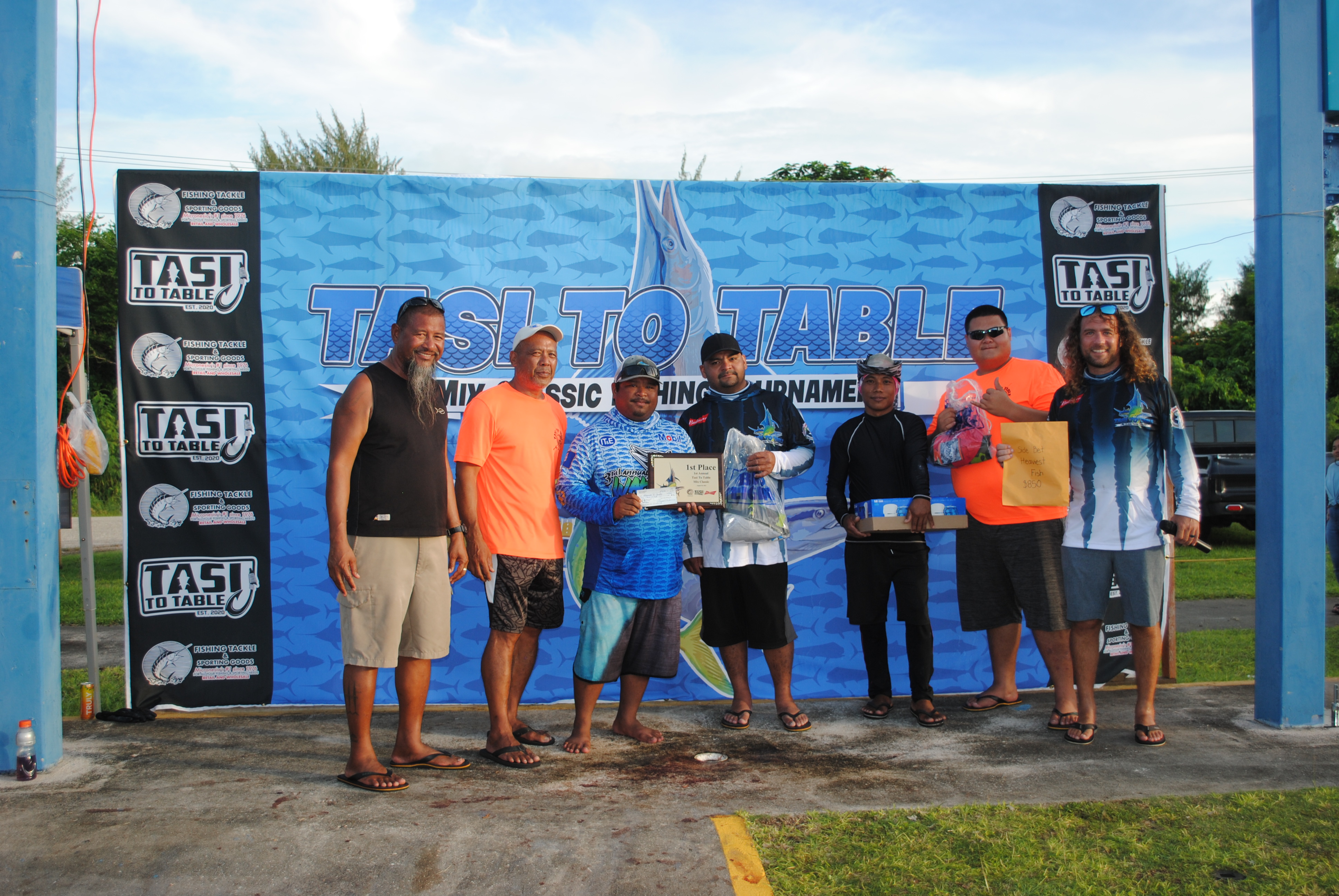 The crew of Carmelita II, which finished first, poses for  a photo with Tasi To Table officials at the conclusion of the 1st Annual Mix Classic on Saturday at Smiling Cove Marina.