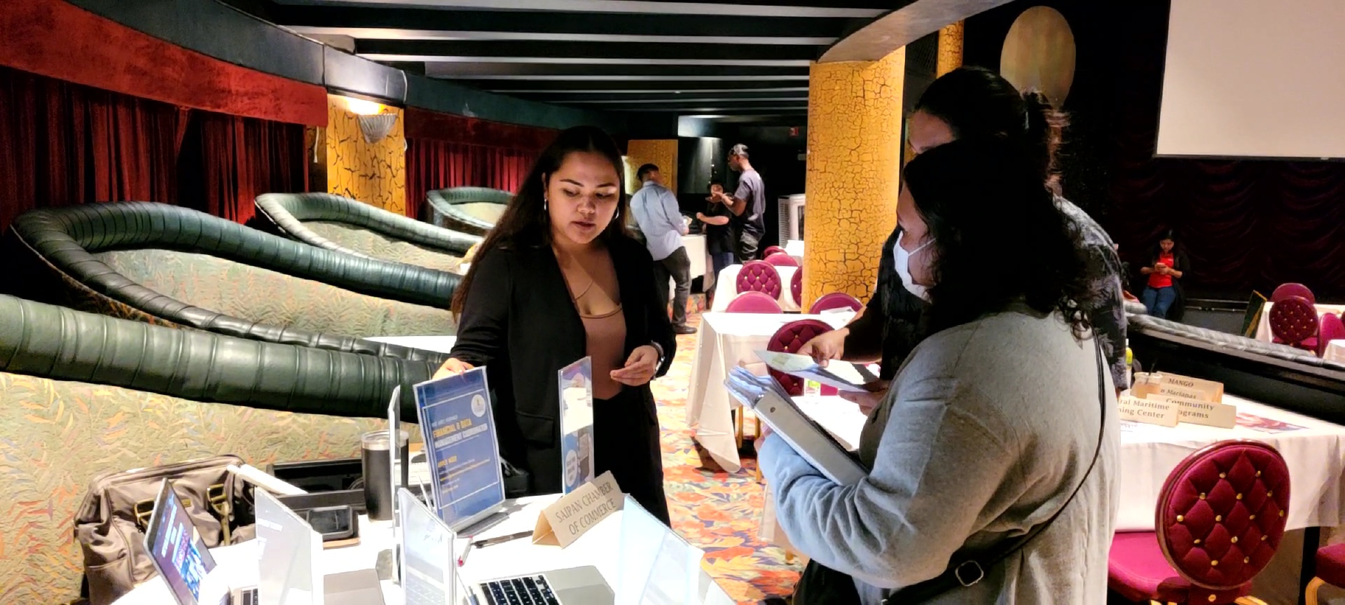 Saipan Chamber of Commerce Executive Director Kimberly C. Camacho assists two jobseekers during the job fair on Friday afternoon at the Hyatt.
