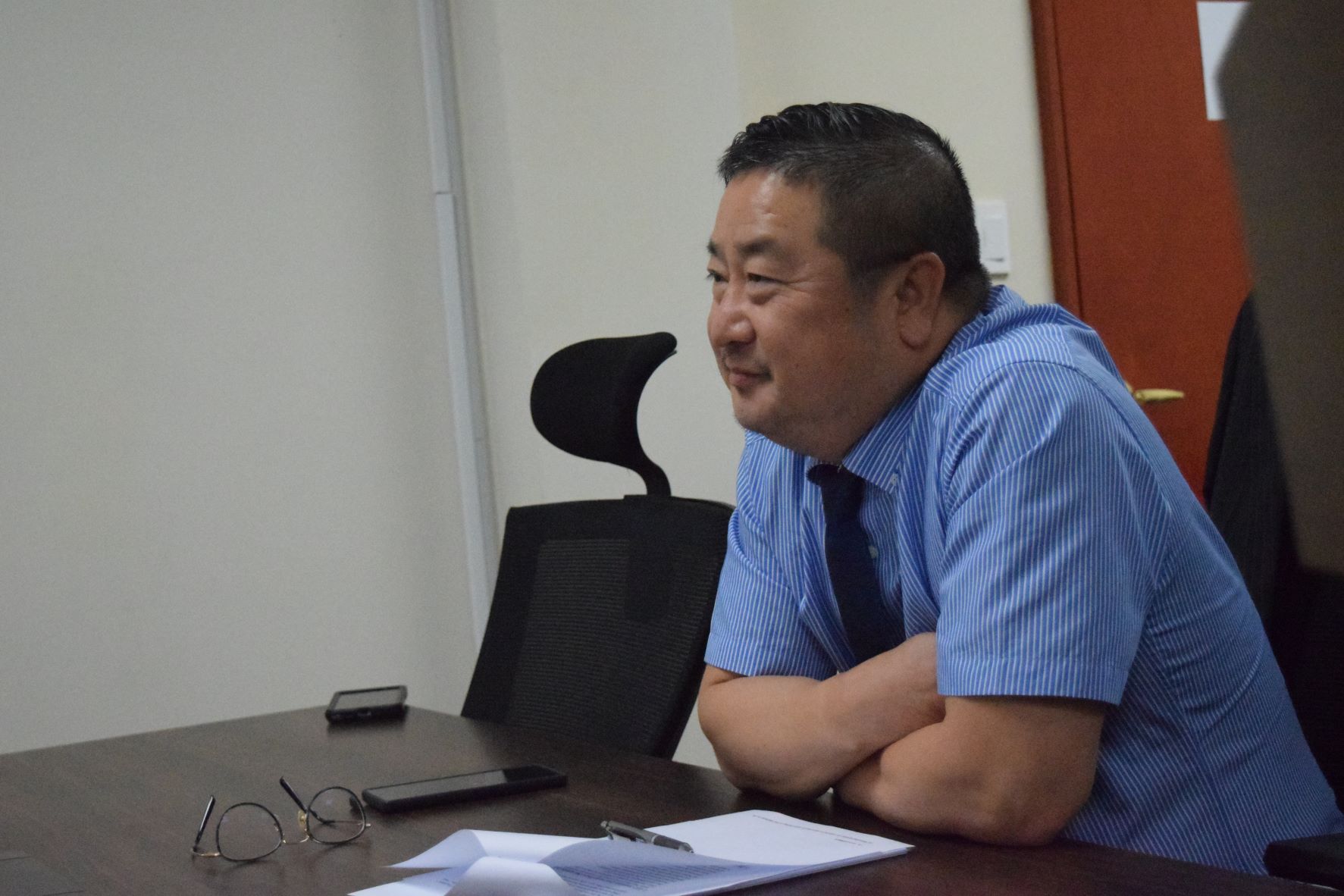Commonwealth Casino Commission Executive Director Andrew Yeom smiles during a casino commission meeting on Thursday in their conference room at Springs Plaza in Gualo Rai.