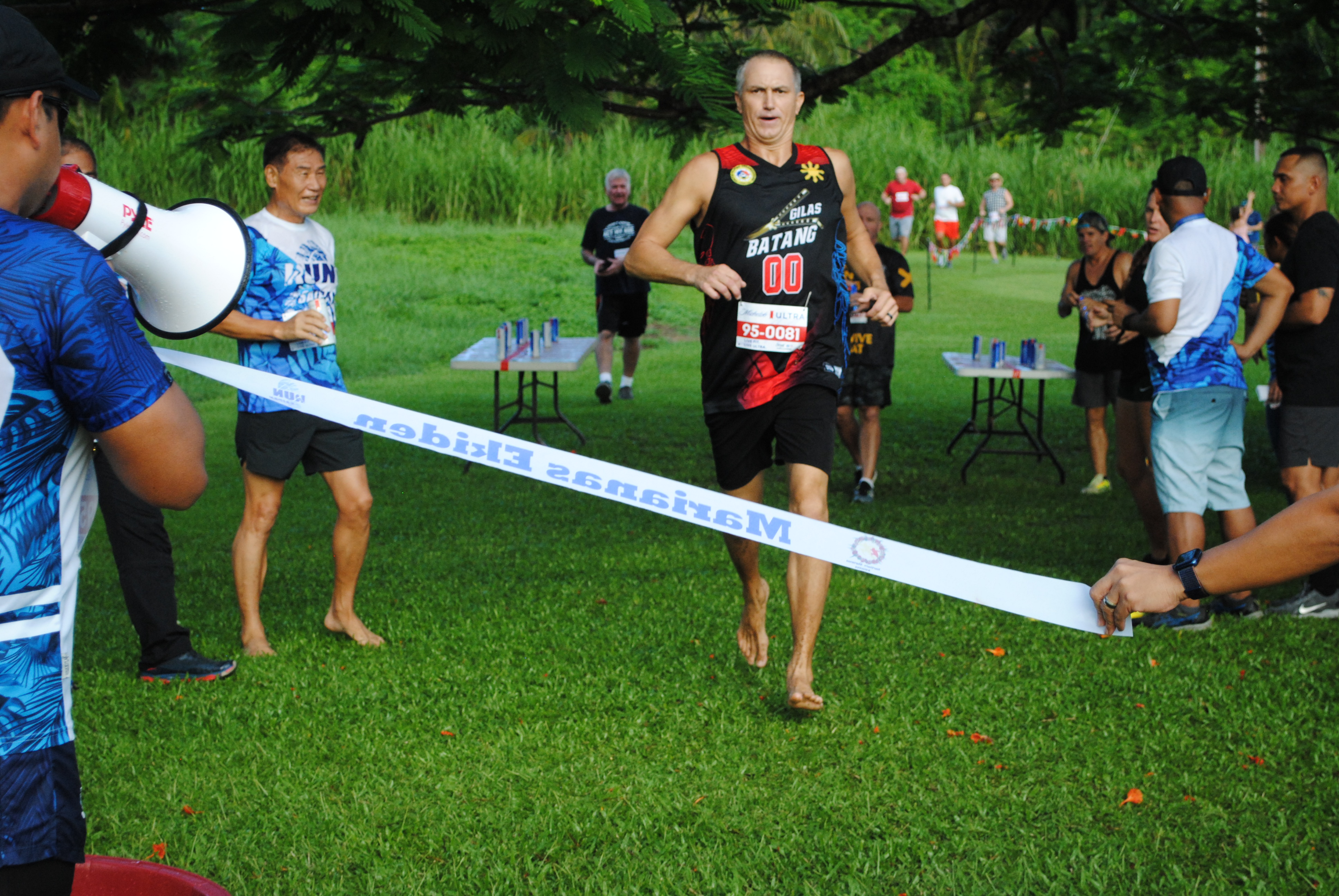 Leith Poole runs toward the finish line to finish first in the 1st Michelob Ultra Beer Mile on Friday at Saipan Country Club.