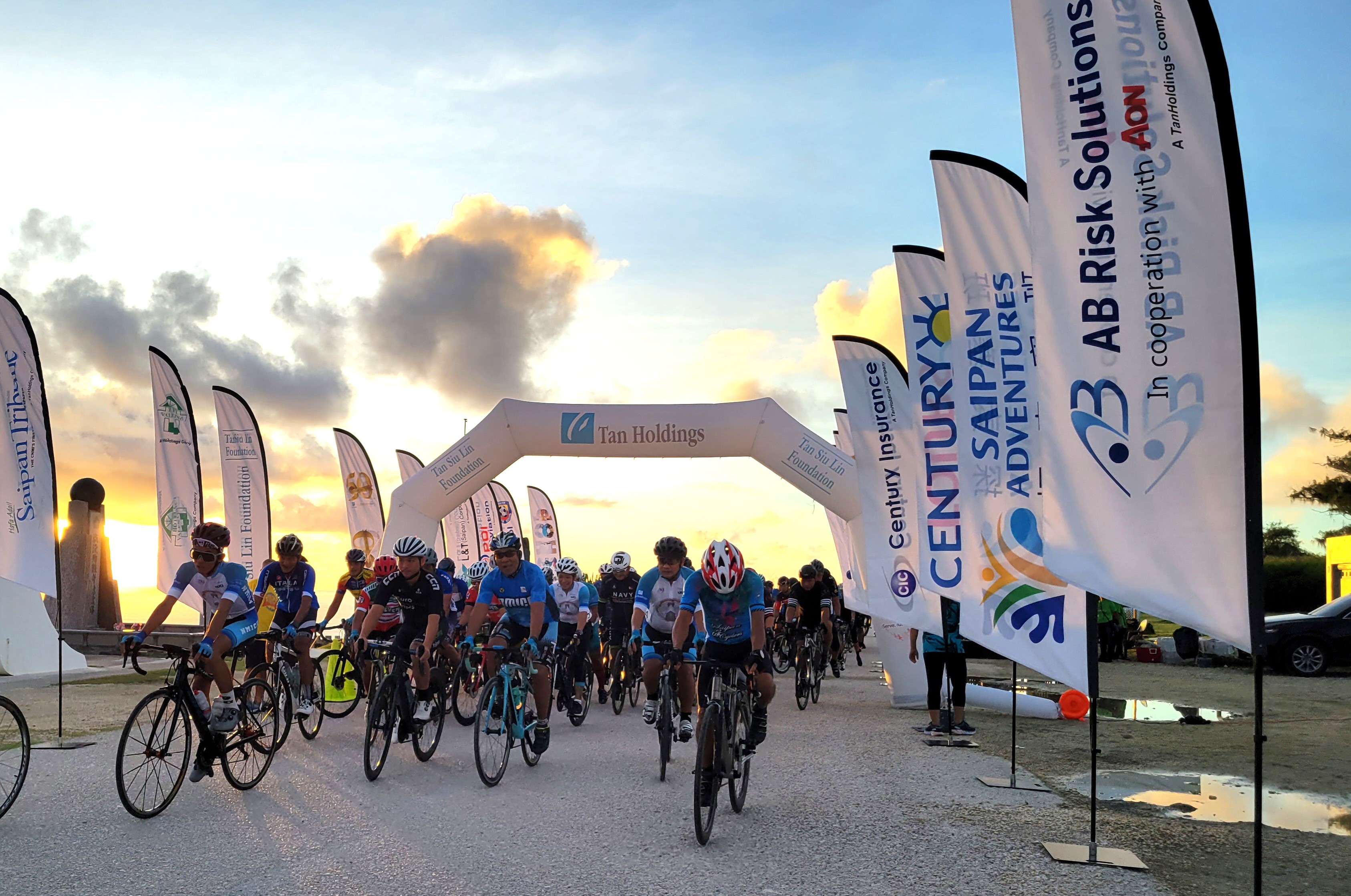 Participants take off at the starting line of the 50th Tan Holdings Anniversary 50KM Bike Race on Saturday in Marpi.