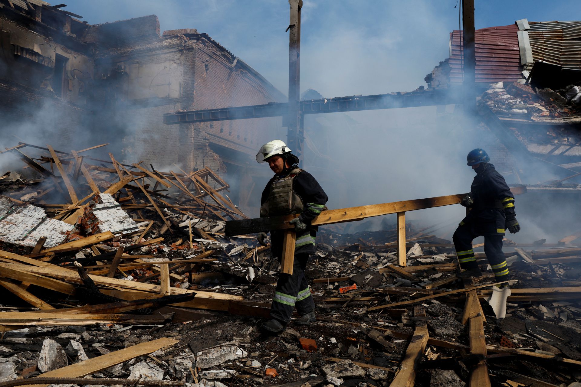 Ukrainian firefighters remove rubbles in a factory destroyed by a Russian strike in the city of Slovyansk, in war-affected area in eastern Ukraine, as Russia's attack in Ukraine continues, in Donetsk region, Ukraine, Aug. 27,2022.