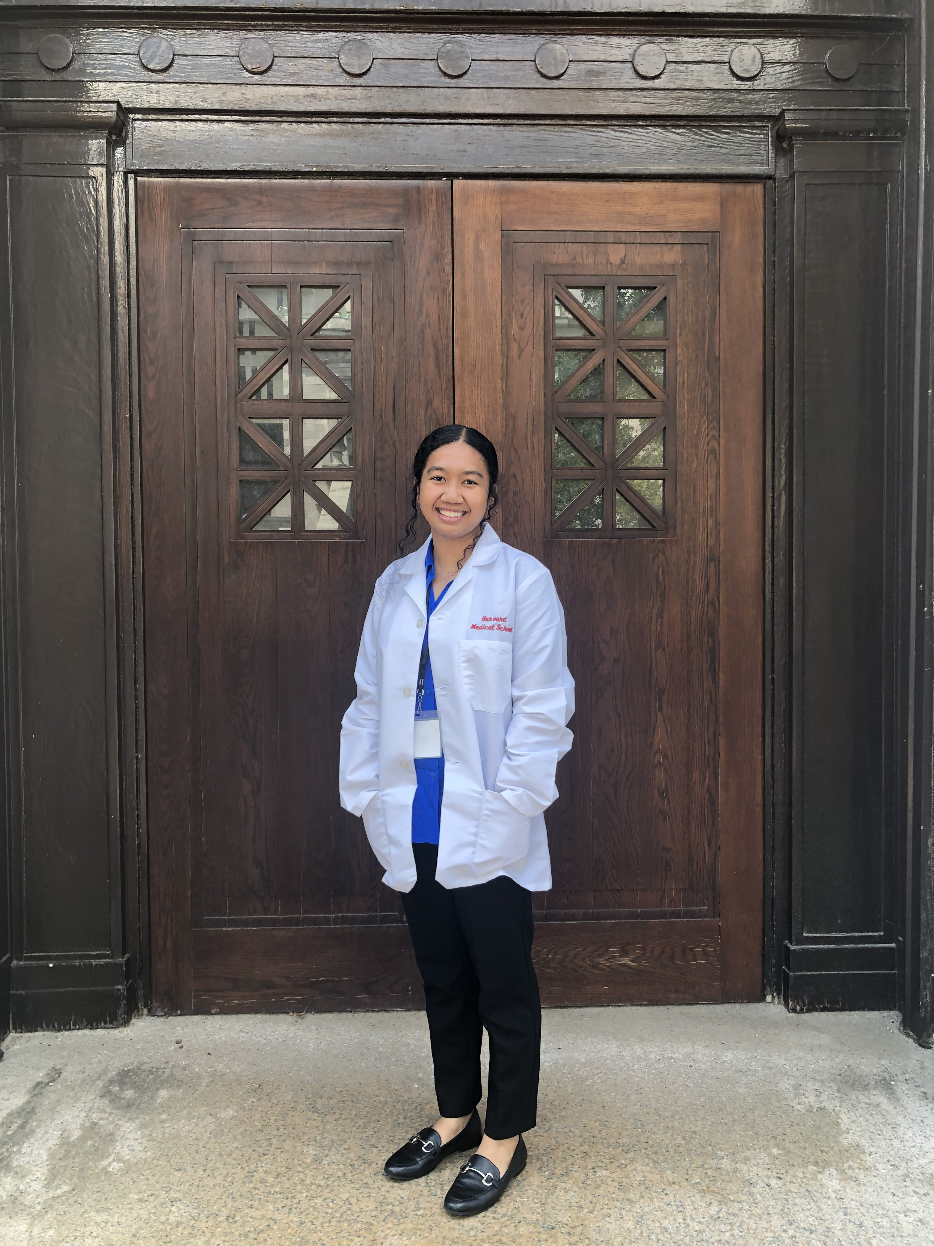 Megan Gimmen wears her lab coat on the Harvard Medical School campus, where she began a four-year Doctor of Medicine on Aug. 1.