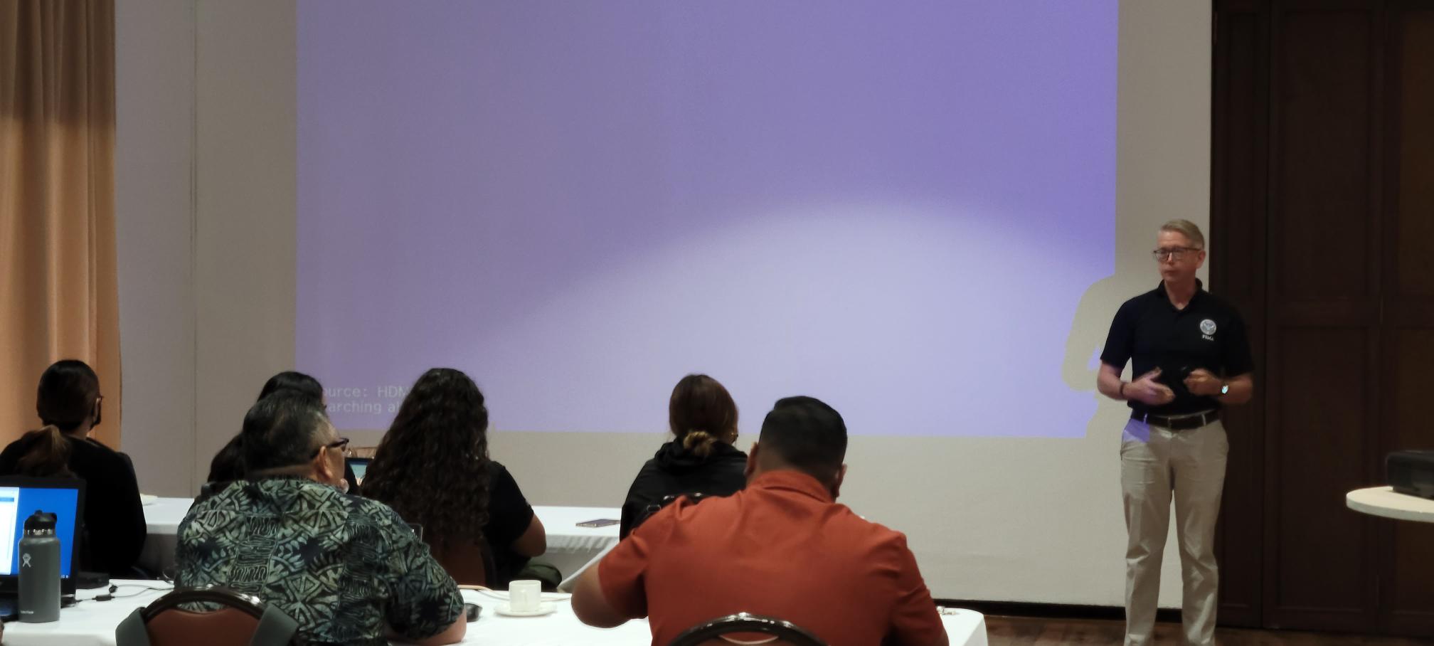 FEMA Joint Recovery Office Director Randy Clayton, right, speaks to Public Assistance Office staff on Tuesday at Aqua Resort Club Saipan.