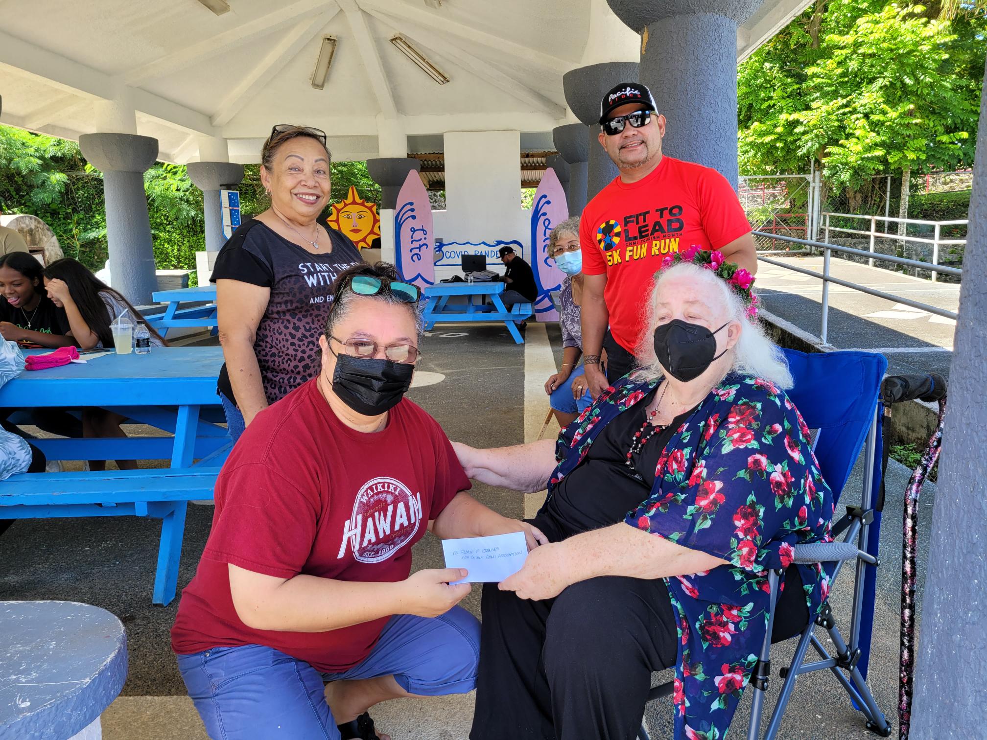 Floria James of ACH Chuuk CNMI Association hands over their monetary donation to Saipan Seniors Advisory Council President Genia Draper on Saturday. Also in photo are Jackie Villagomez and Senate Floor Leader Vinnie Sablan.