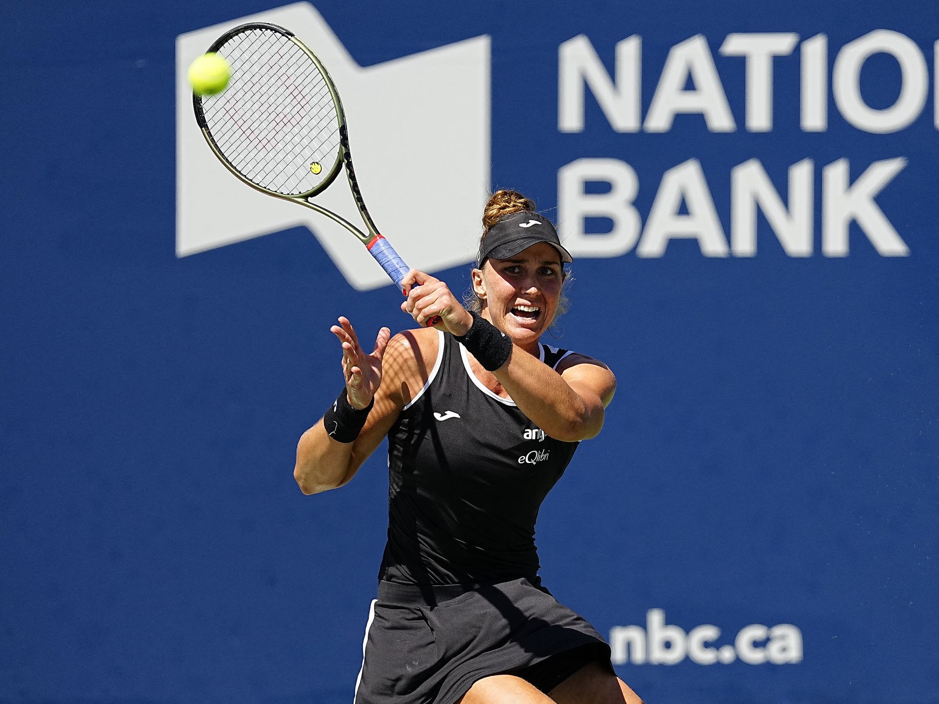 Beatriz Haddad Maia hits a ball to Simona Halep — not pictured —  in the women's final of the National Bank Open at Sobeys Stadium in Toronto, Ontario, Canada on Aug. 14, 2022.