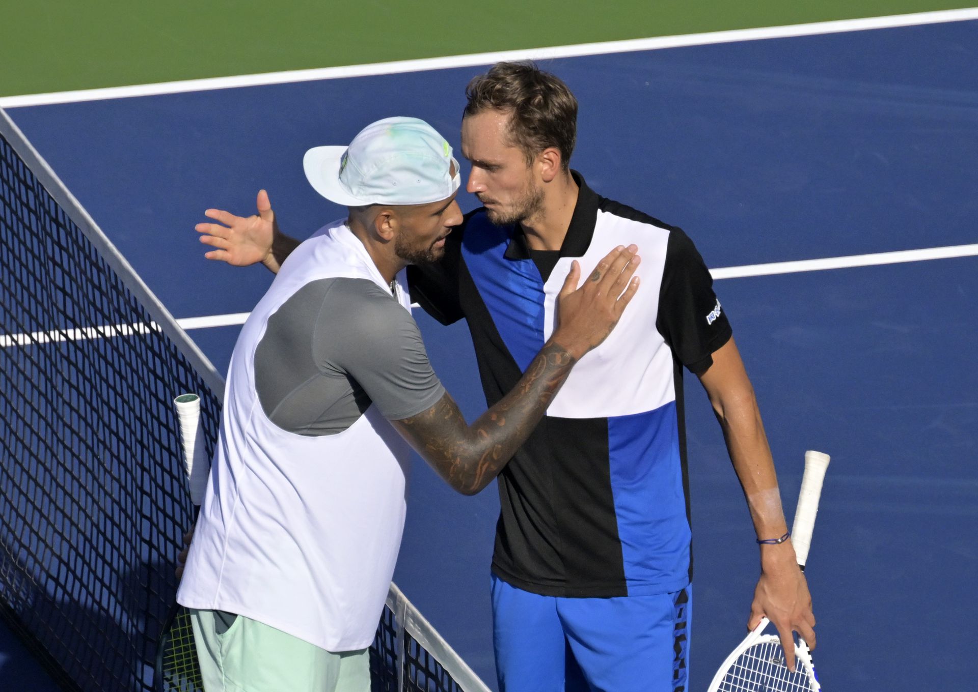 Nick Kyrgios, left, and Daniil Medvedev hug in second round play at the IGA Stadium in Montreal, Quebec, Canada on Aug. 10, 2022.