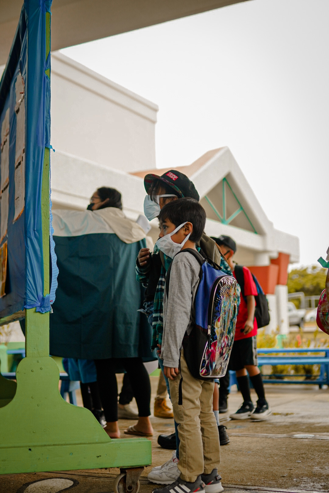 Kagman Elementary School students read the schedules and other information posted on the bulletin board.