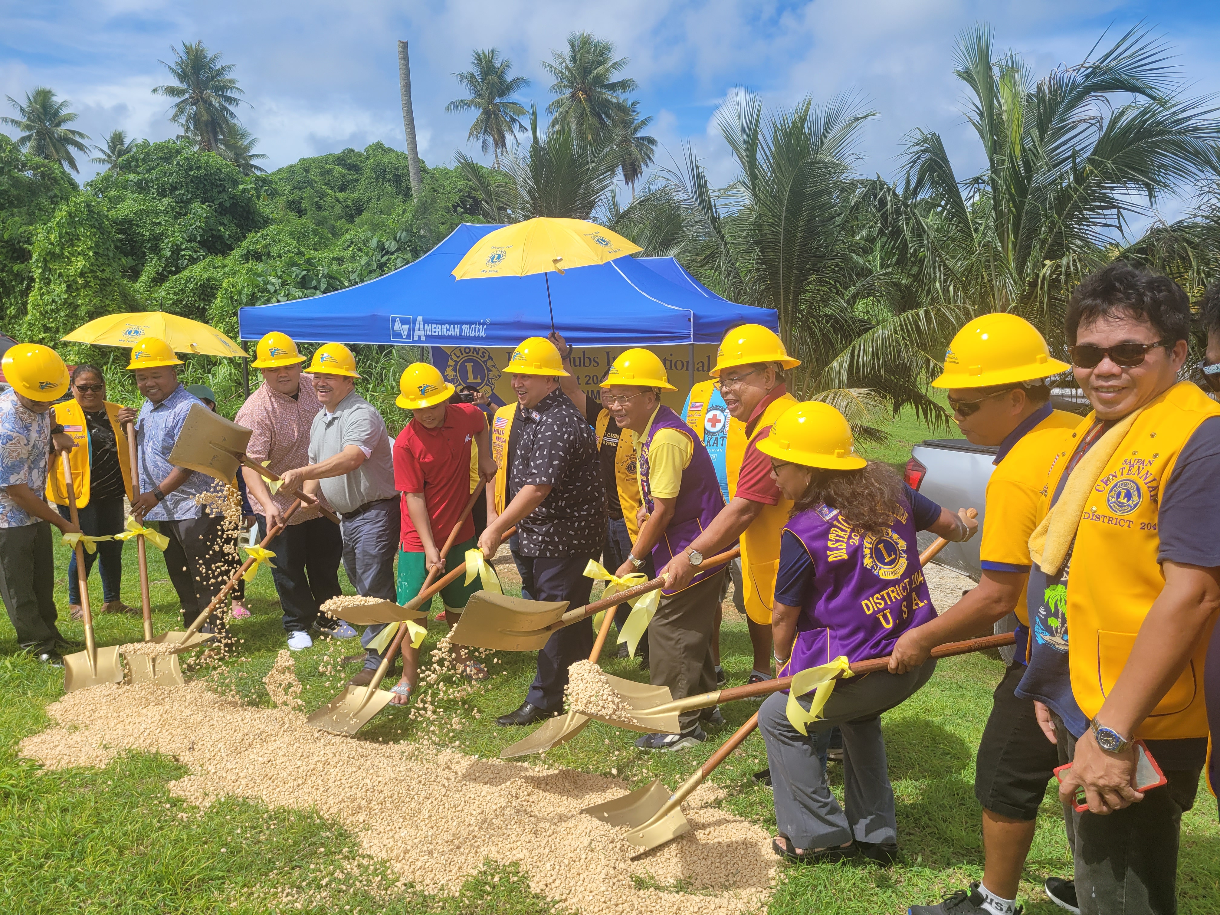 Rep. Roy Ada, House Minority Leader Angel Demapan, Shawn San Nicolas of PSS pupil transportation, Education Commissioner Dr. Alfred Ada, and Gov. Ralph DLG Torres join District 204 Gov. Atoy Banting, other Lions Club members and community members in a groundbreaking ceremony for a new bus shelter near As Terlaje hill.