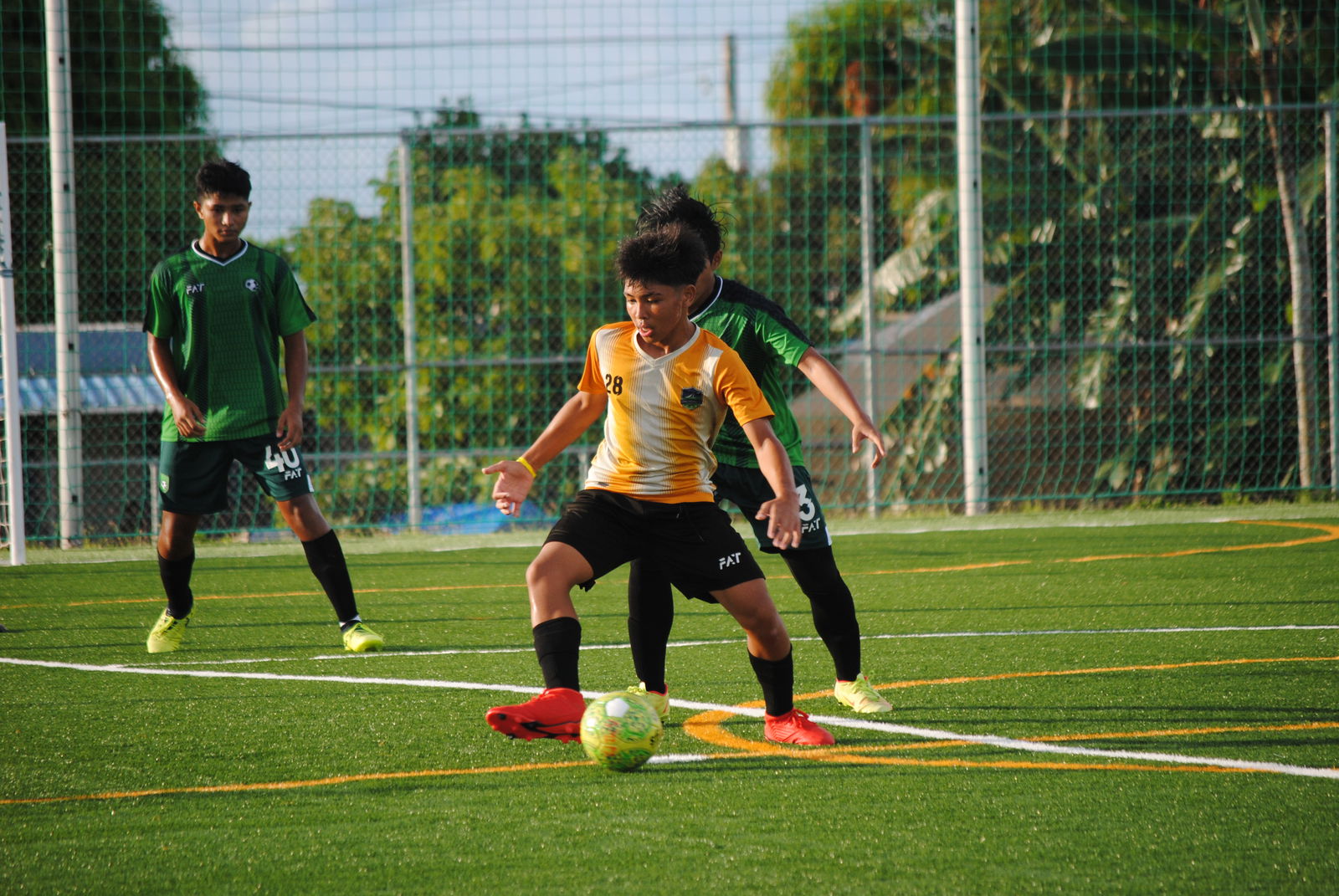 Kanoa's Paul Lizama sets up the play as a defender attempts the steal.