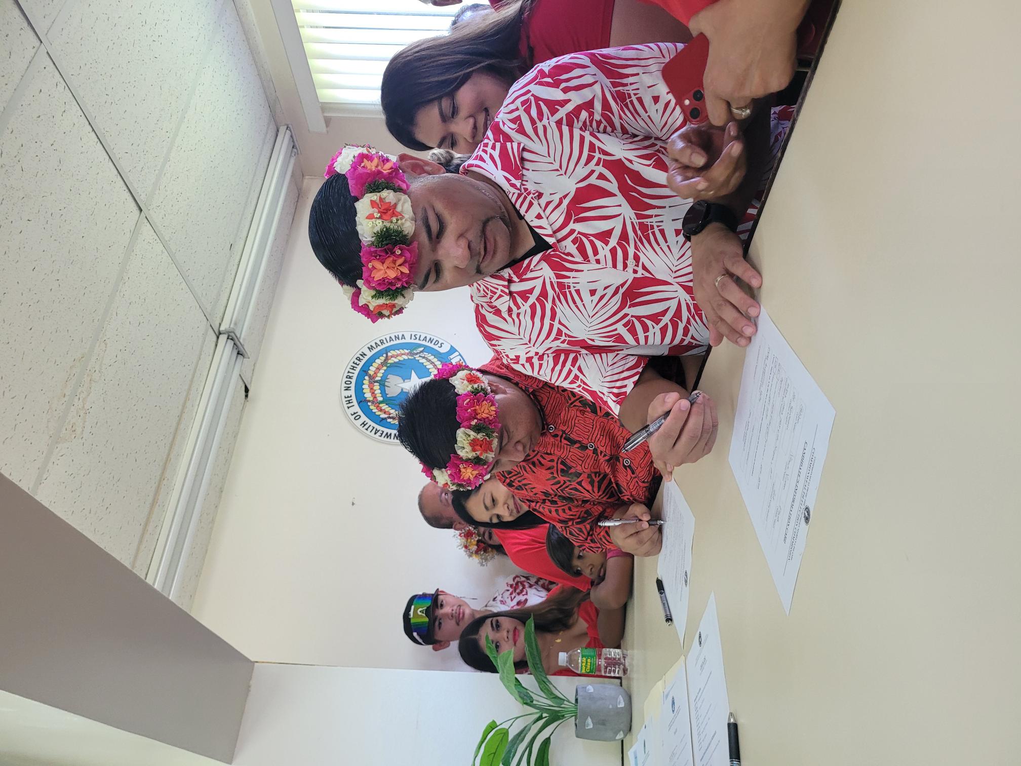 While family members and other supporters look on, Gov. Ralph DLG Torres and running mate Senate Floor Leader Vinnie F. Sablan file their candidacies at the Commonwealth Election Office Friday.