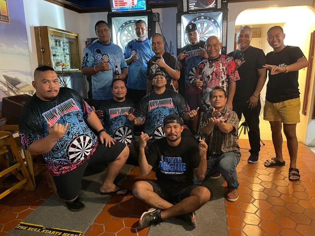 The Oleai Dart Daddies and the JC Serial Killers pose for a photo after their match Thursday in the Flame Tree Thursday “B” Division of the SEDA Bud Light Dart League at Rendezvous.
