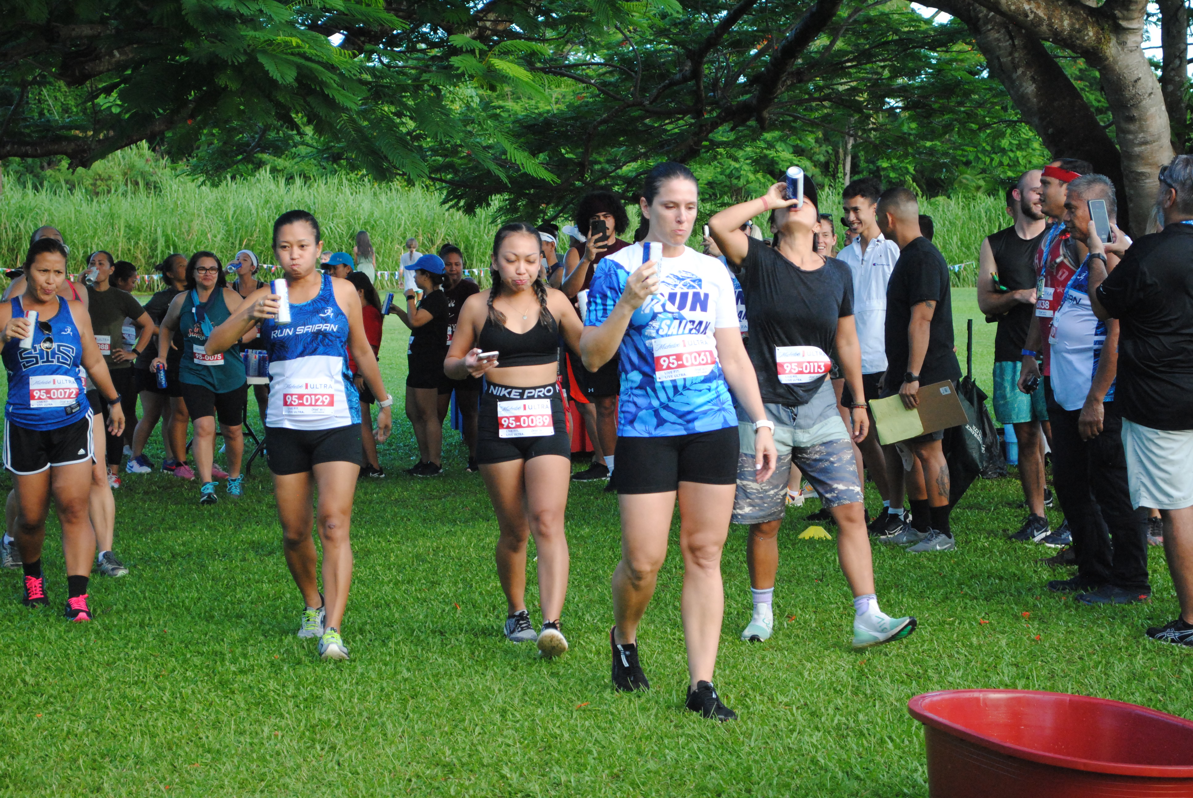 Participants finish a can of Michelob Ultra after completing a lap.