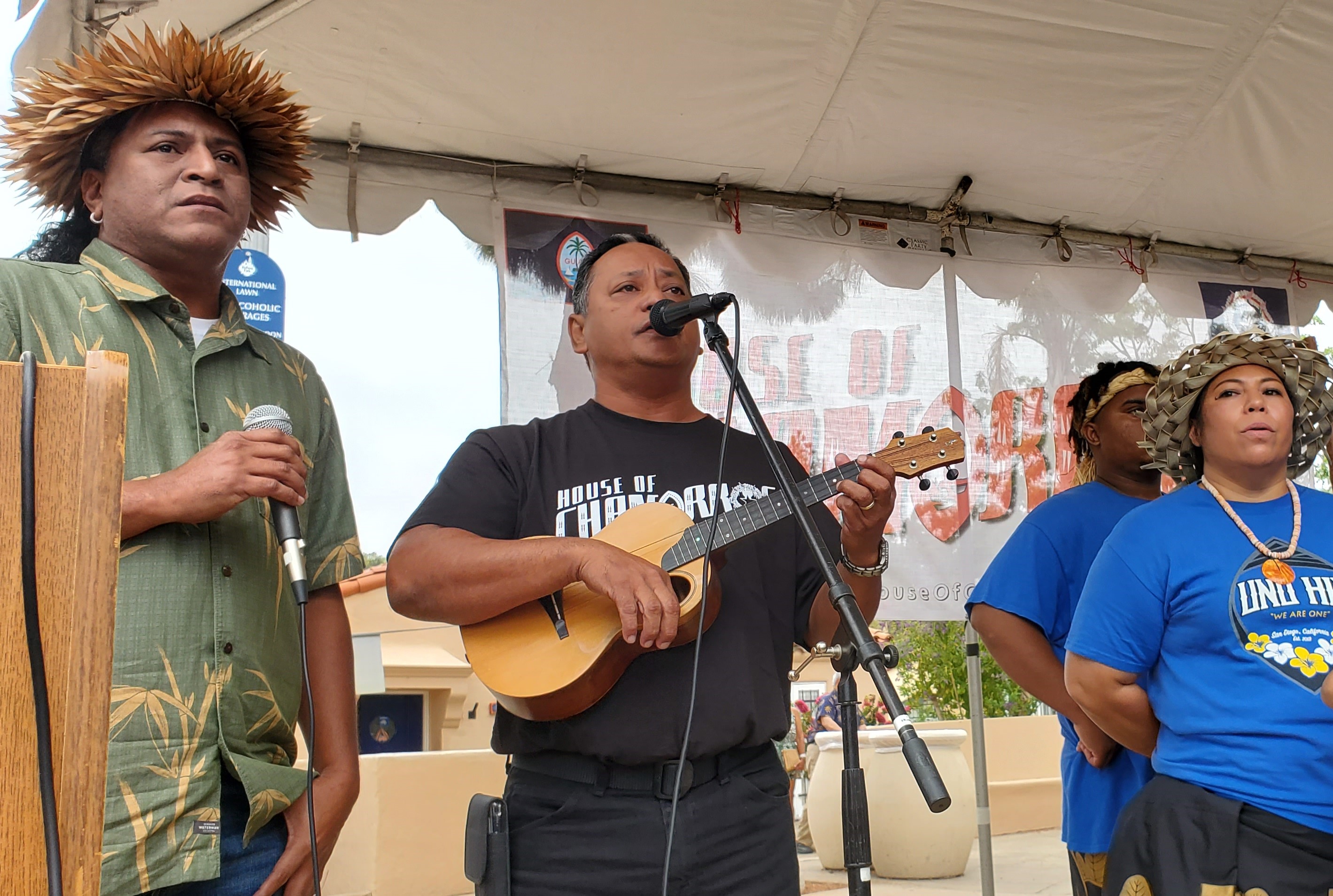 Commonwealth Council for Arts and Culture Executive Director Parker Yobei and Indigenous Affairs Office Resident Director Roman Tudela Jr. sing the national anthem during the House of Chamorros grand opening ceremonies.
