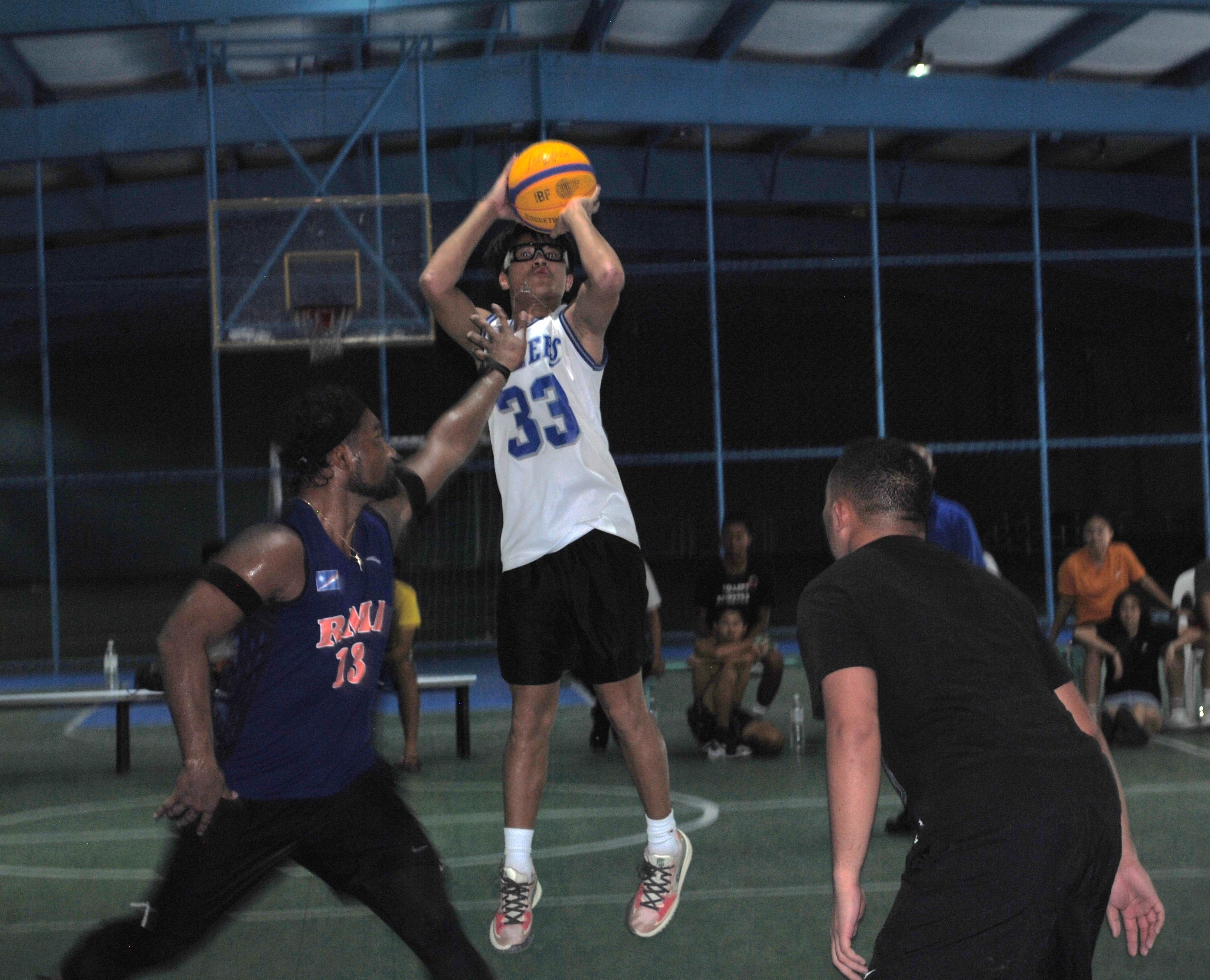Bench Buddies' Ervin Villarin takes the contested jump shot in the finals of the Northern Mariana Islands Basketball Federation’s Three vs Three Hoop Fest Tournament at the TSL Sports Complex on Saturday.