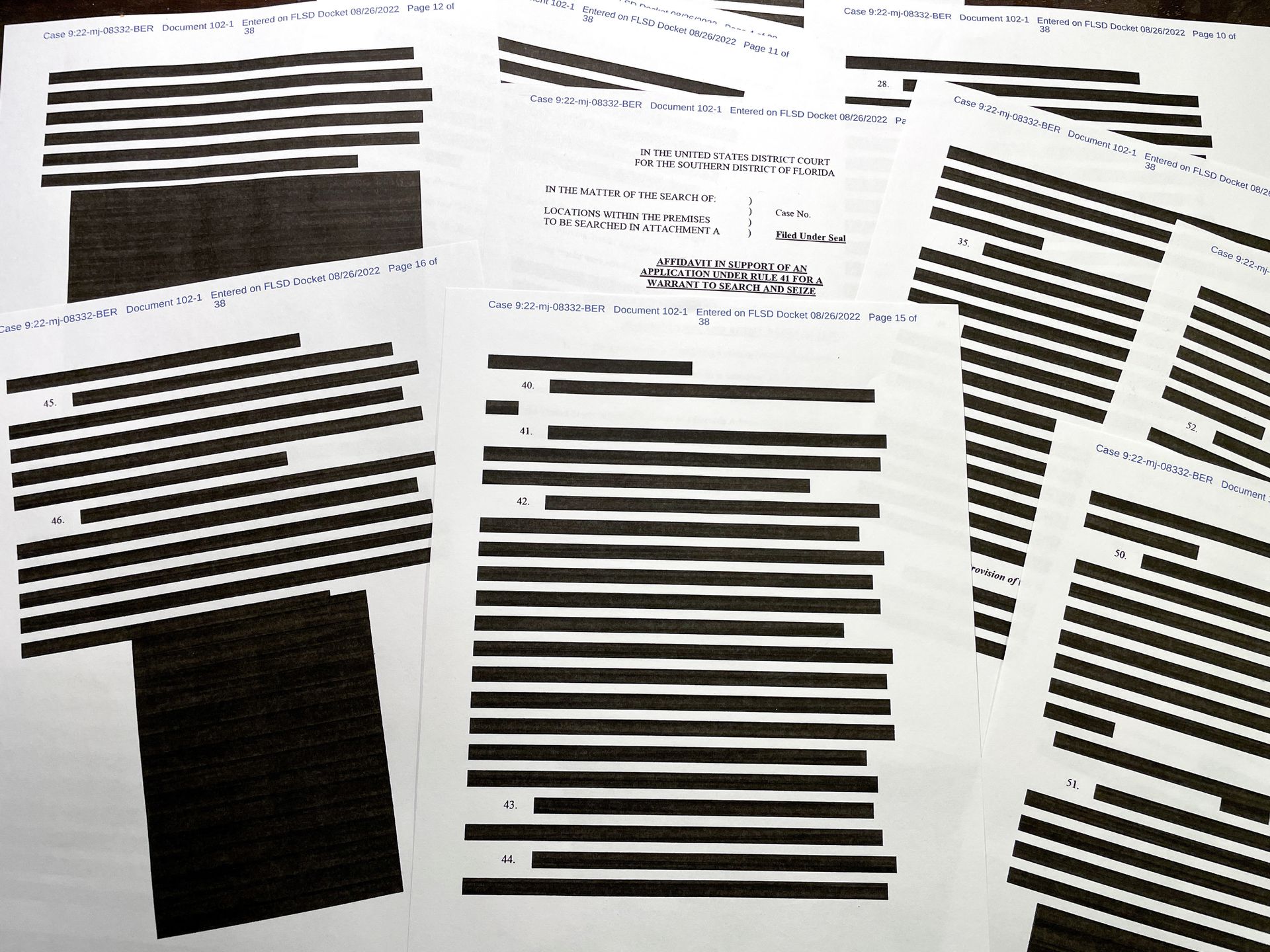 Pages of entirely redacted information are seen in the released version of an affidavit from the U.S. Justice Department that was submitted to a federal judge to support the execution of a search warrant by the FBI at former President Donald Trump's Mar-a-Lago estate after the affidavit was released to the public on Aug. 26, 2022 by the U.S. District Court for the Southern District of Florida with more than half the information in the document redacted.