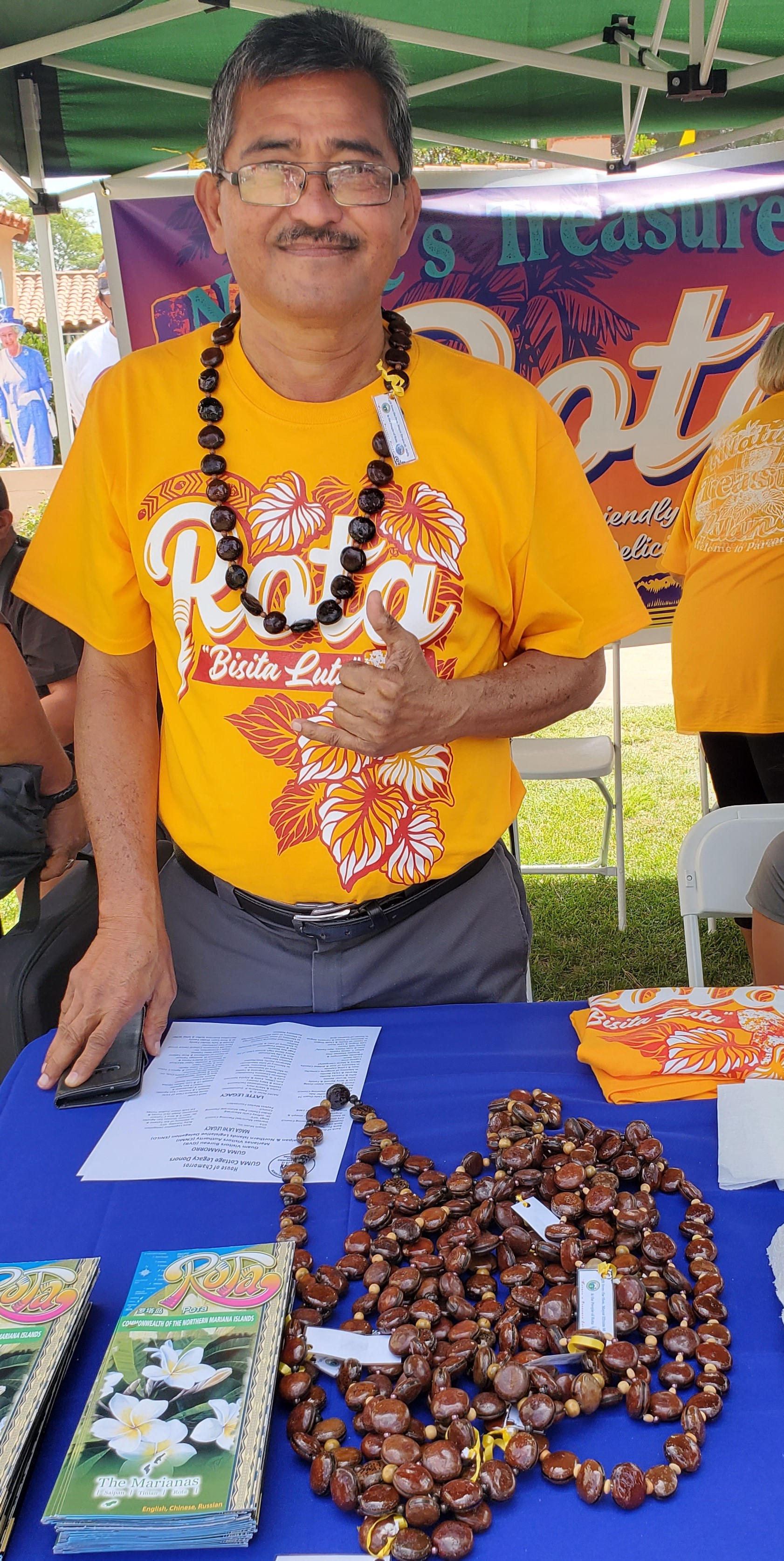 Rota Mayor Efraim M. Atalig greets visitors at the Rota booth during the Hafa Adai Festival.